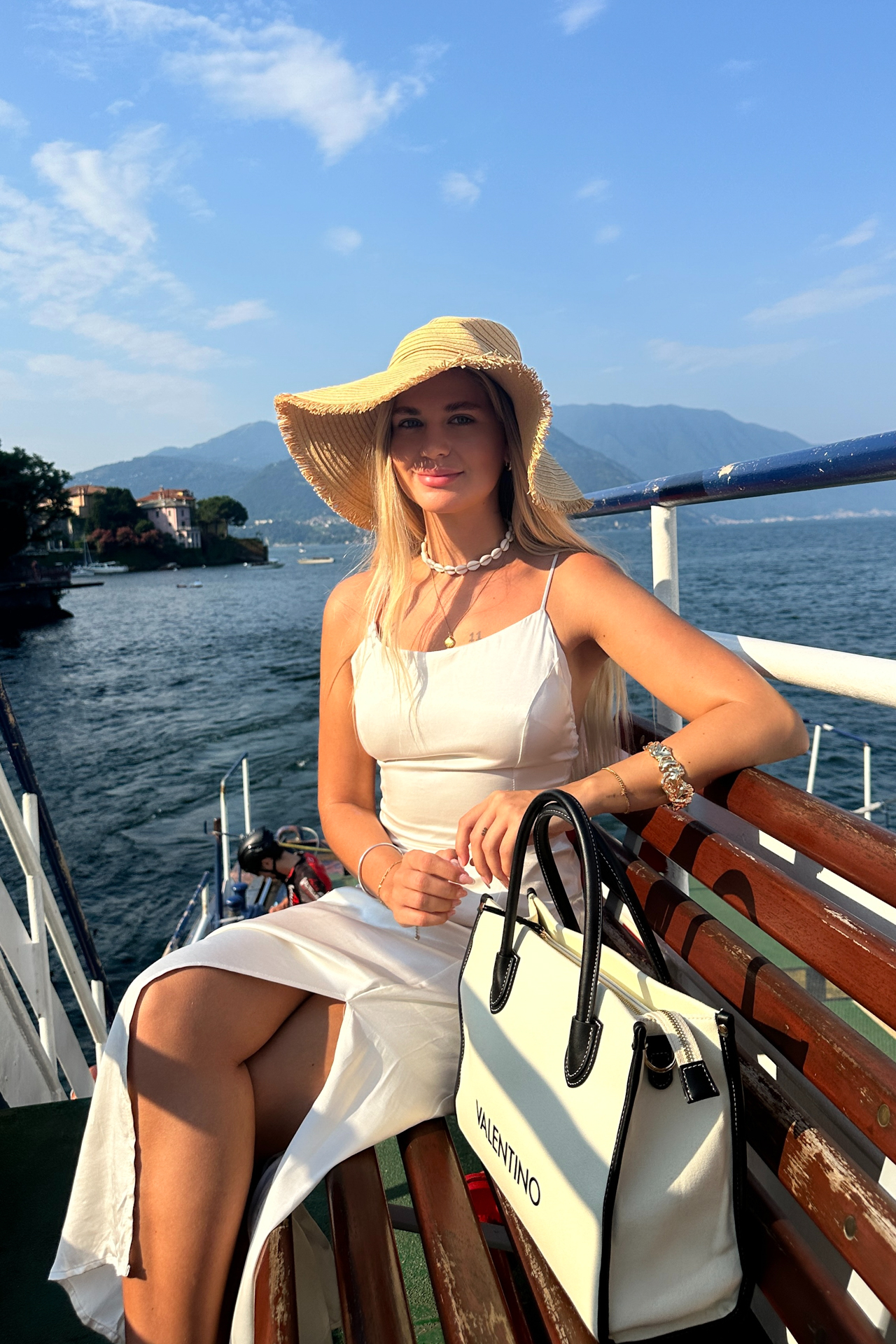 Woman sitting on the ferry in Lake Como on her way to Bellagio.