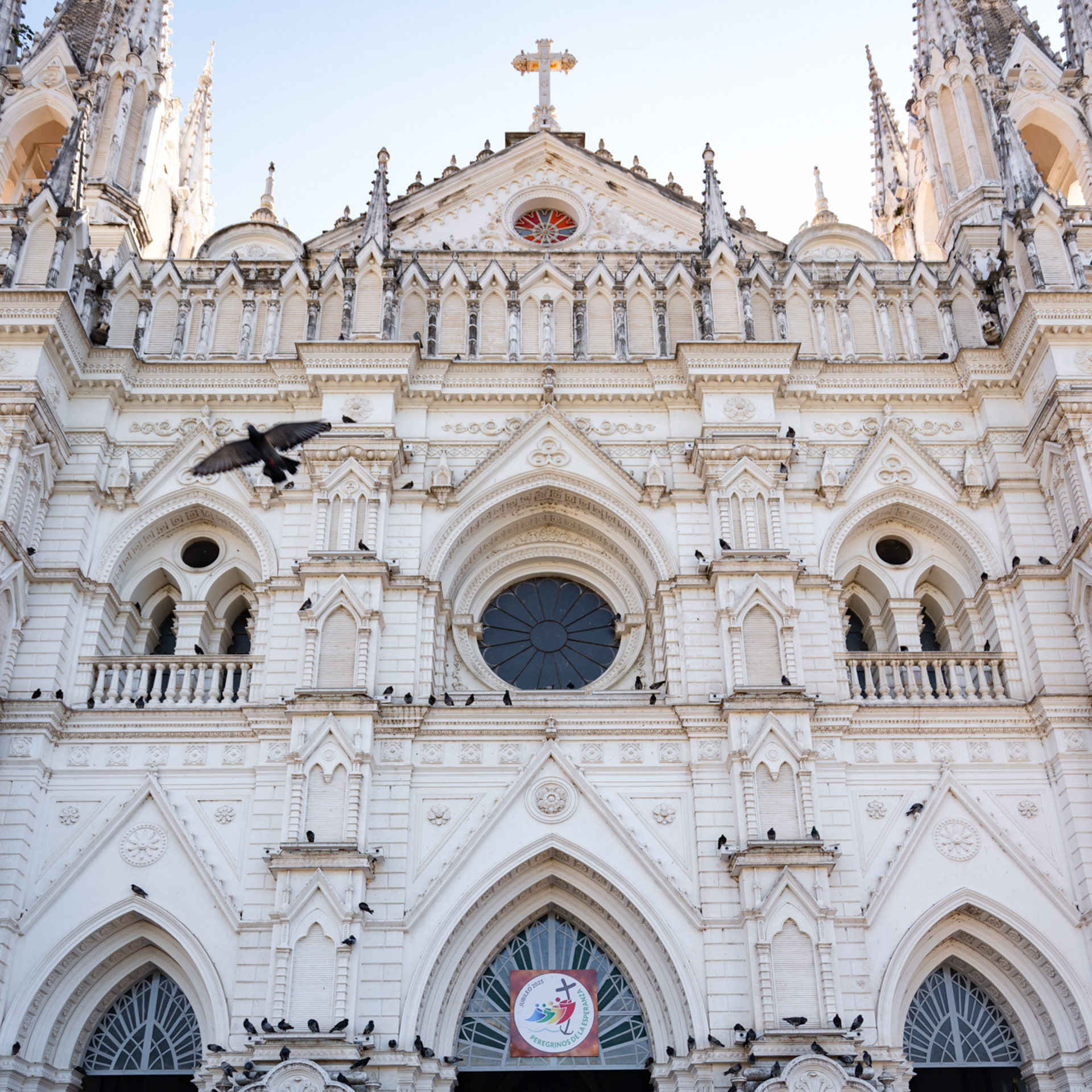 Traditions in El Salvador Front view of the Gothic-style Santa Ana Cathedral in El Salvador with birds flying.
