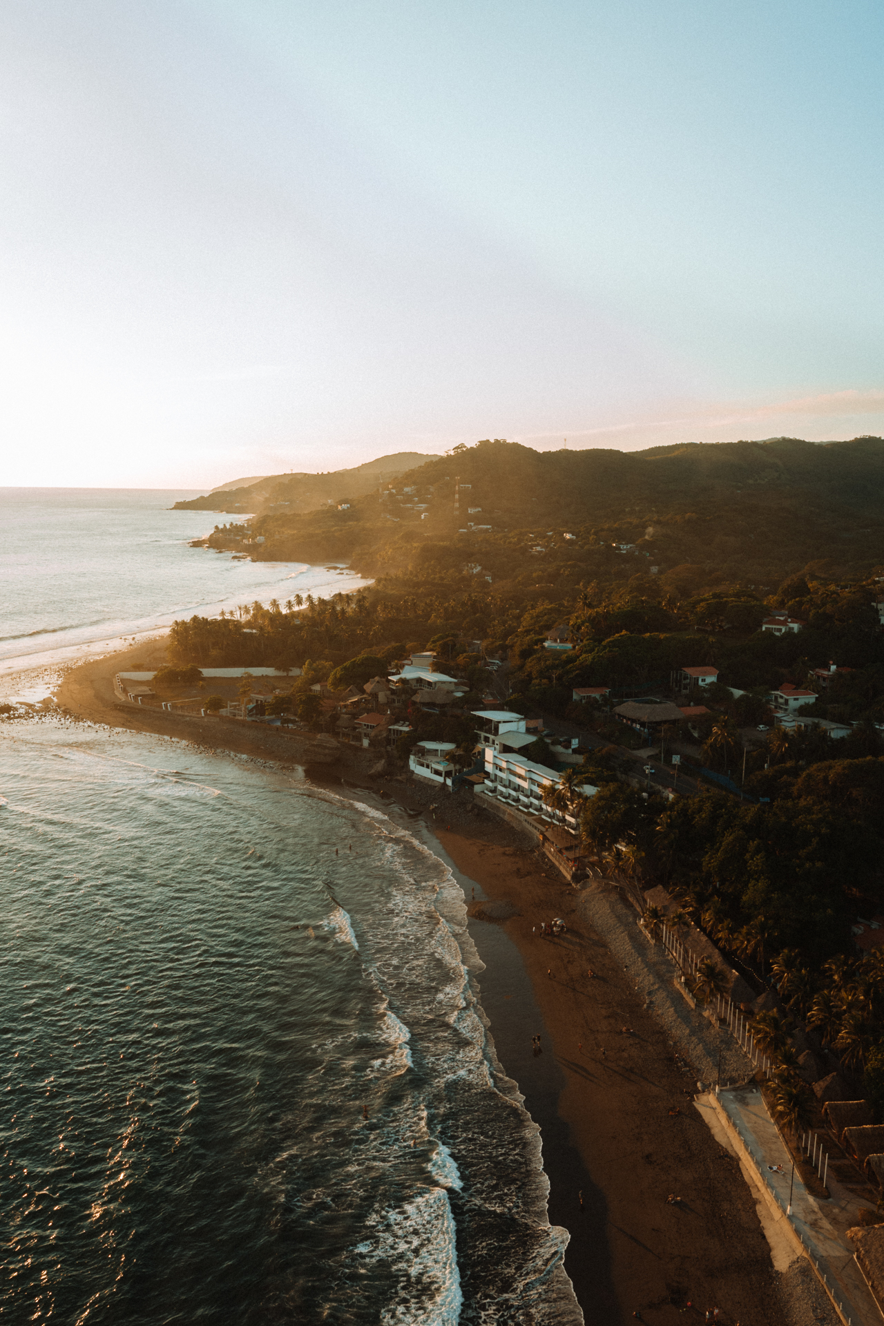 El Tunco Aerial view of El Tunco Beach at sunset, with waves crashing along the coastline of El Salvador.