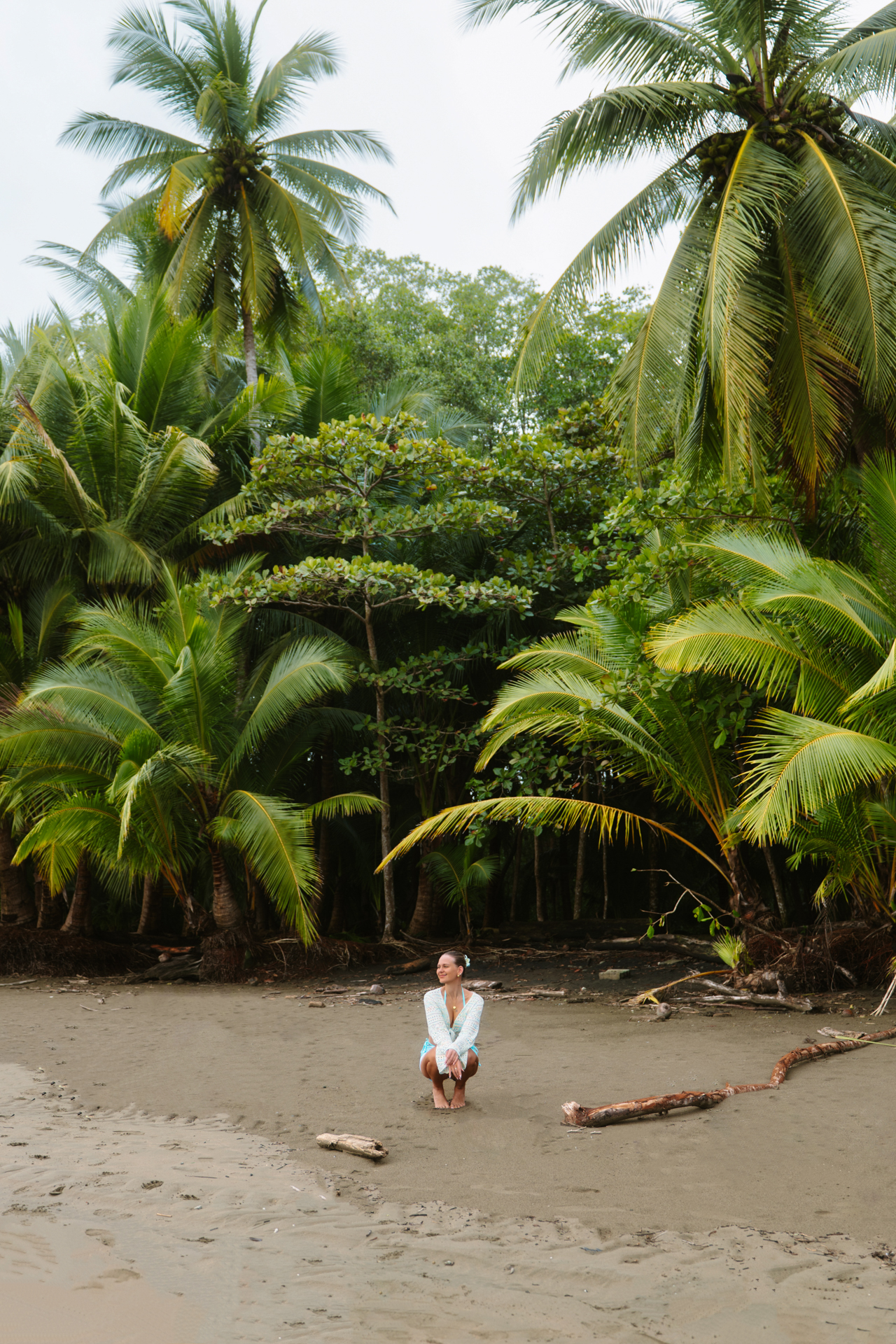 Quiet black sand beach framed by palm trees in Uvita, Costa Rica