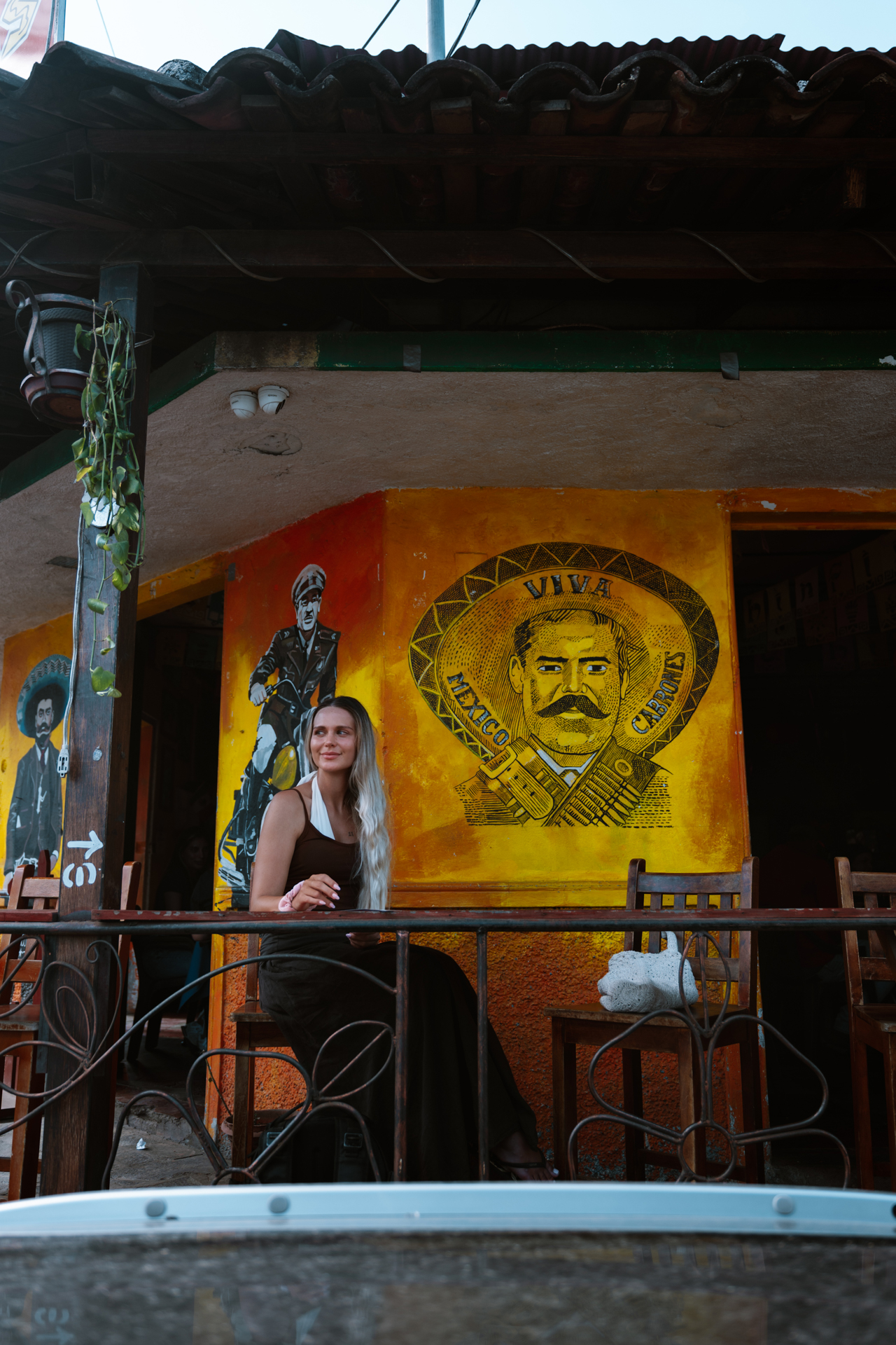 Woman at colorful mural on Ruta de las Flores, El Salvador