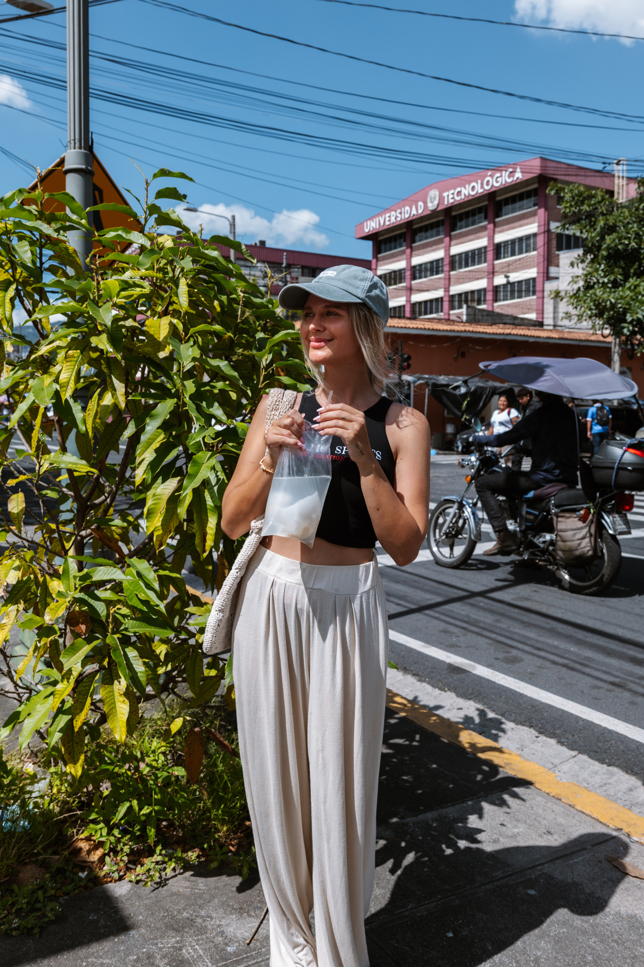 Traveler enjoying coconut drink near Universidad Tecnológica in El Salvador, San Salvador