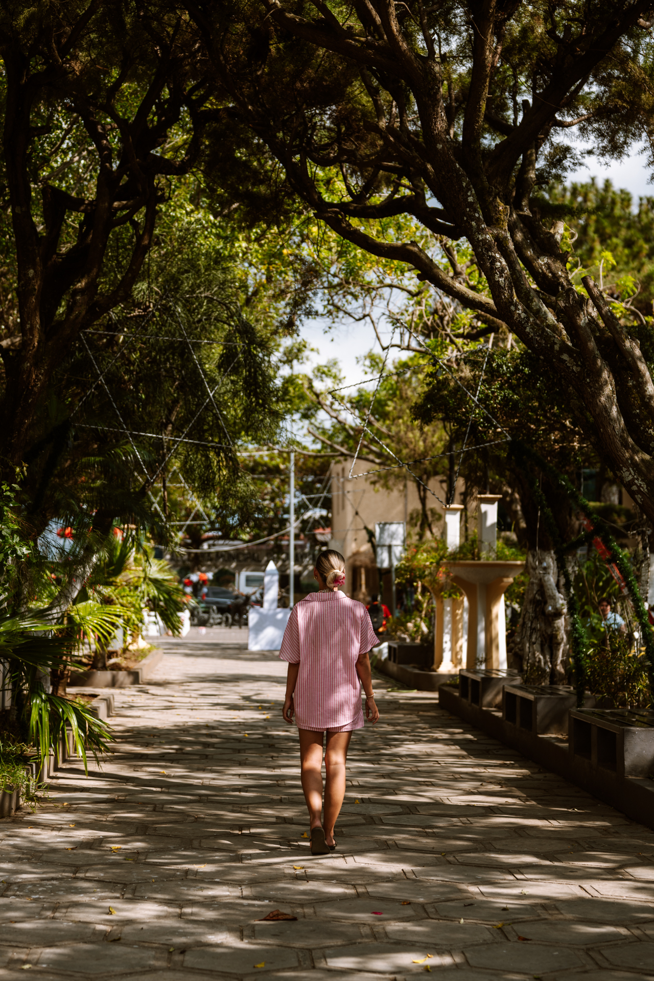 Woman walking through scenic village on Ruta de las Flores, El Salvador