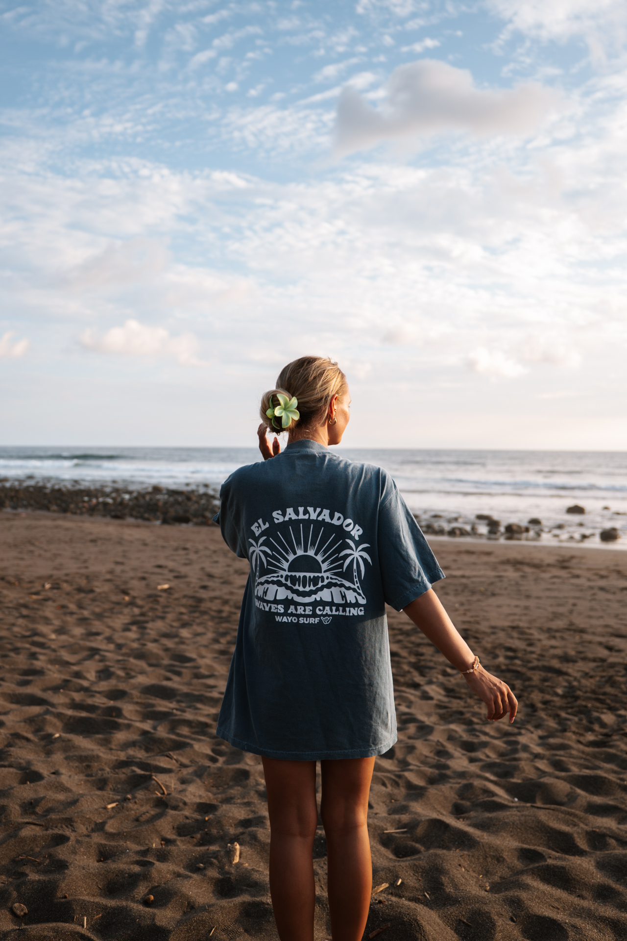 Woman walking on Mizata Beach at sunset, El Salvador