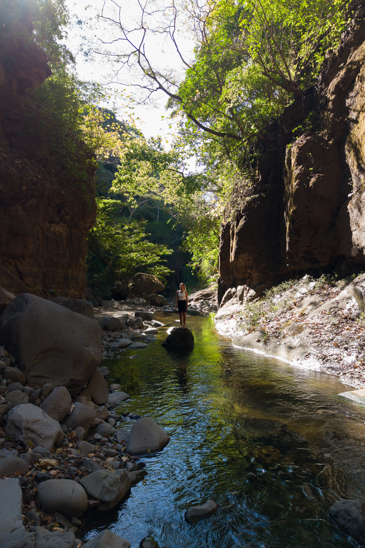 Woman standing in river at Tamanique Waterfalls, El Salvador
