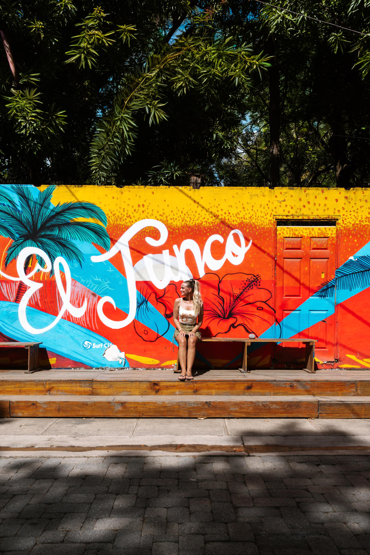 Woman at colorful El Tunco mural, El Salvador