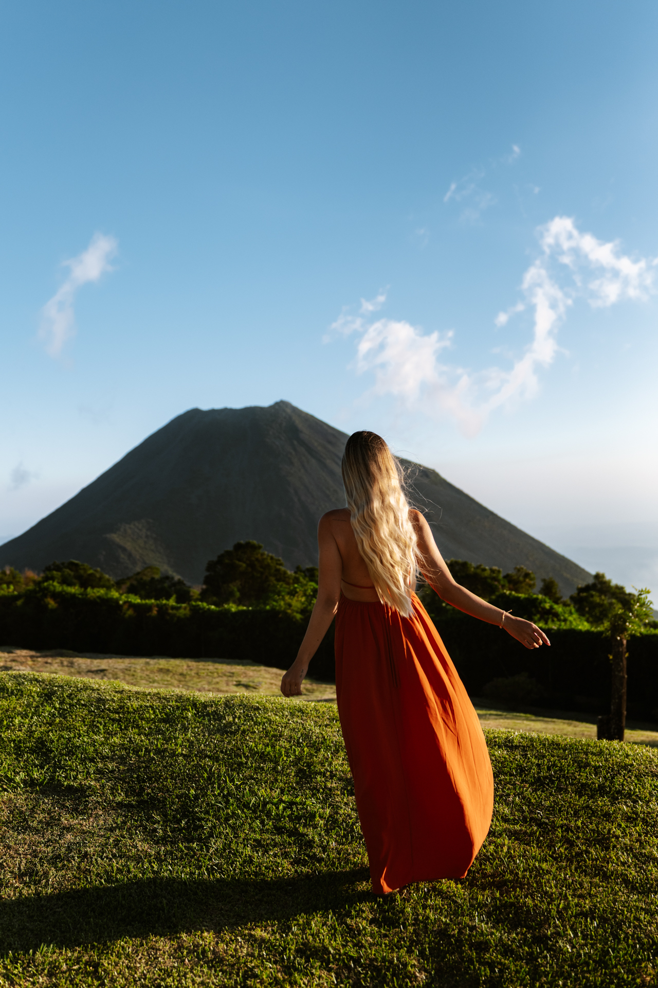Woman in red dress facing Santa Ana Volcano, El Salvador