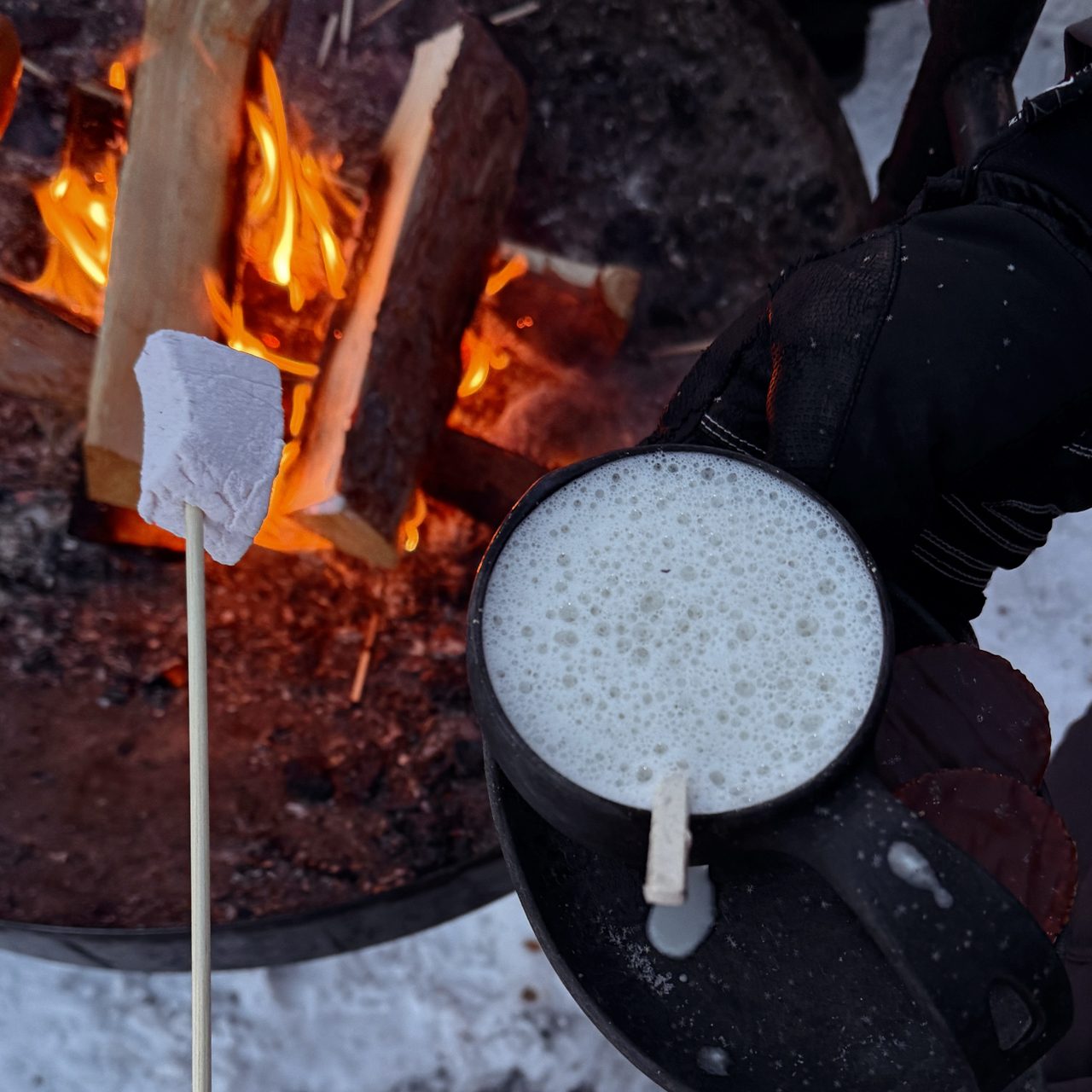 Food in Finland Hot drink by the campfire with marshmallows in snowy Lapland