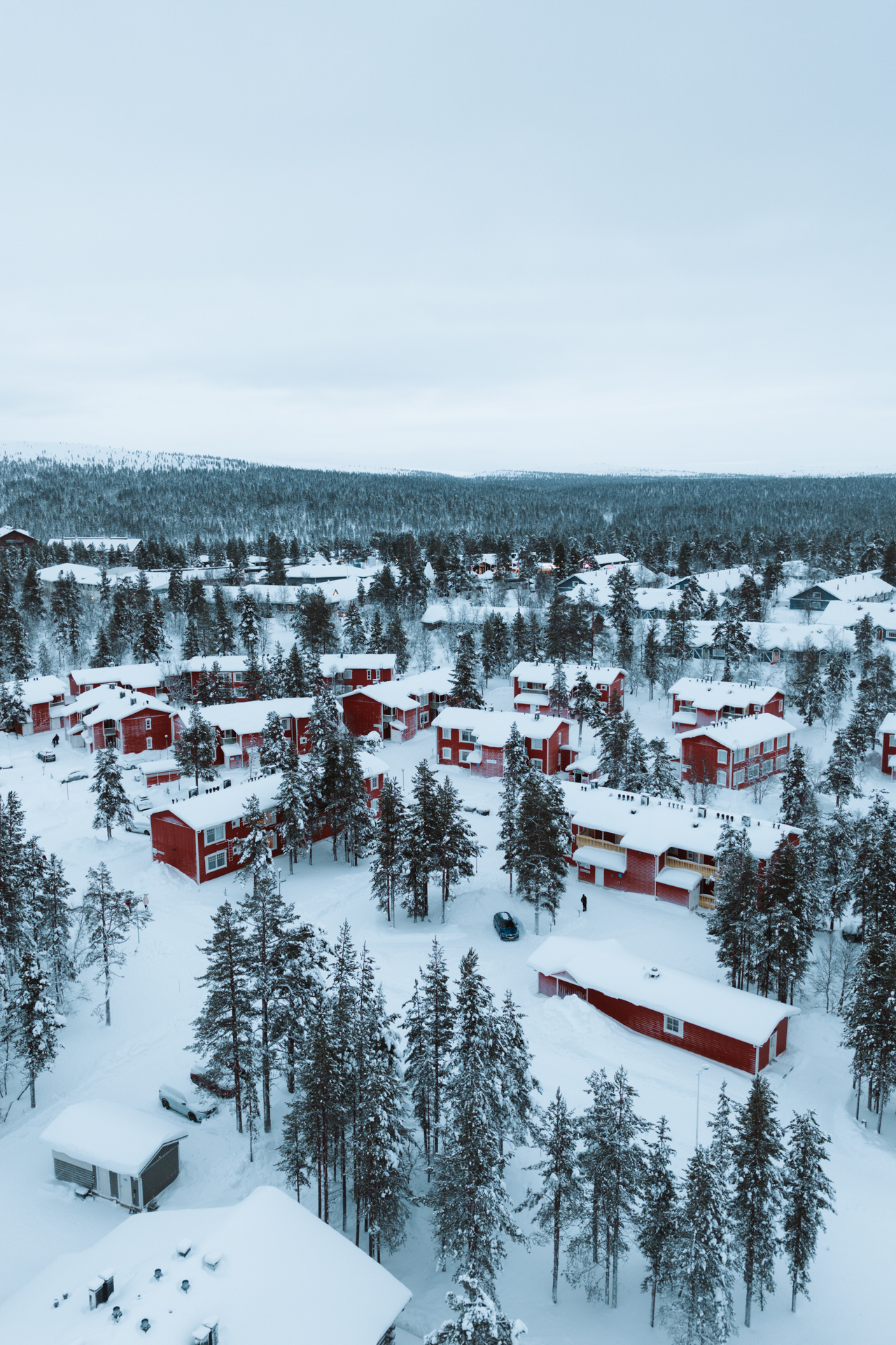 Saariselkä Aerial view of snow-covered cabins and pine forest in Saariselkä, Finland