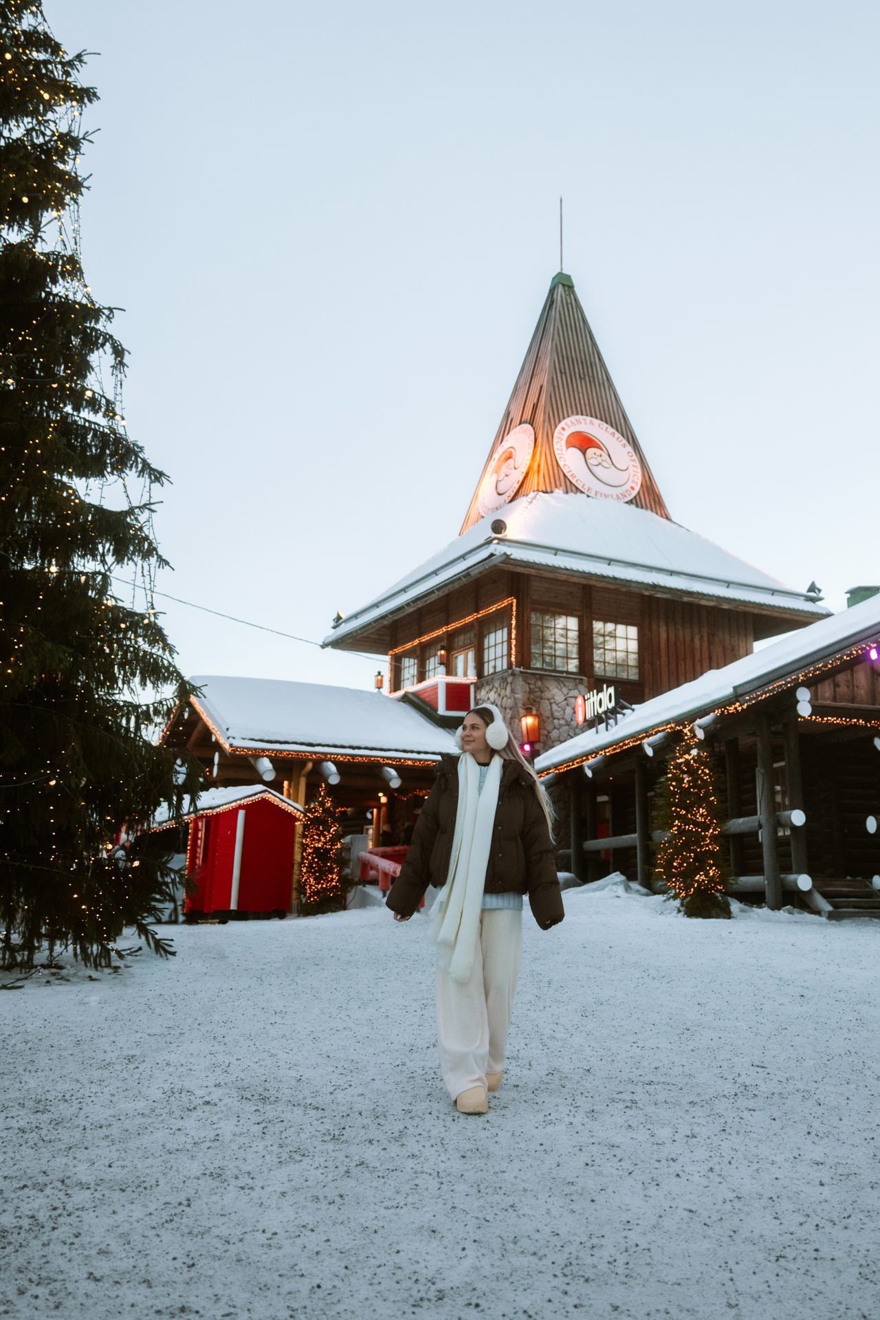 Rovaniemi Woman walking through Santa Claus Village in Rovaniemi, Finland during winter