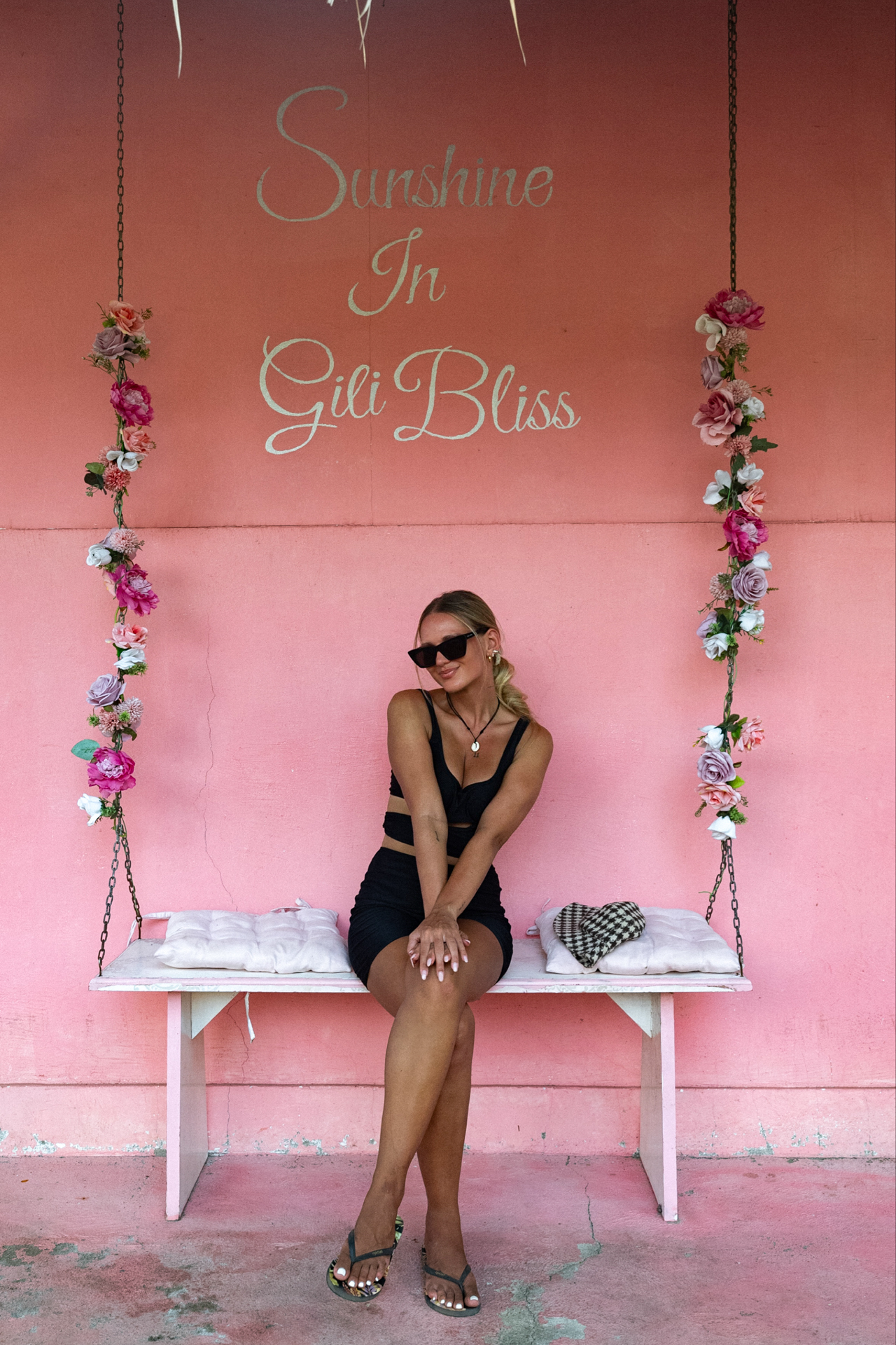 Traveler posing on pink swing wall in Gili Air, Lombok