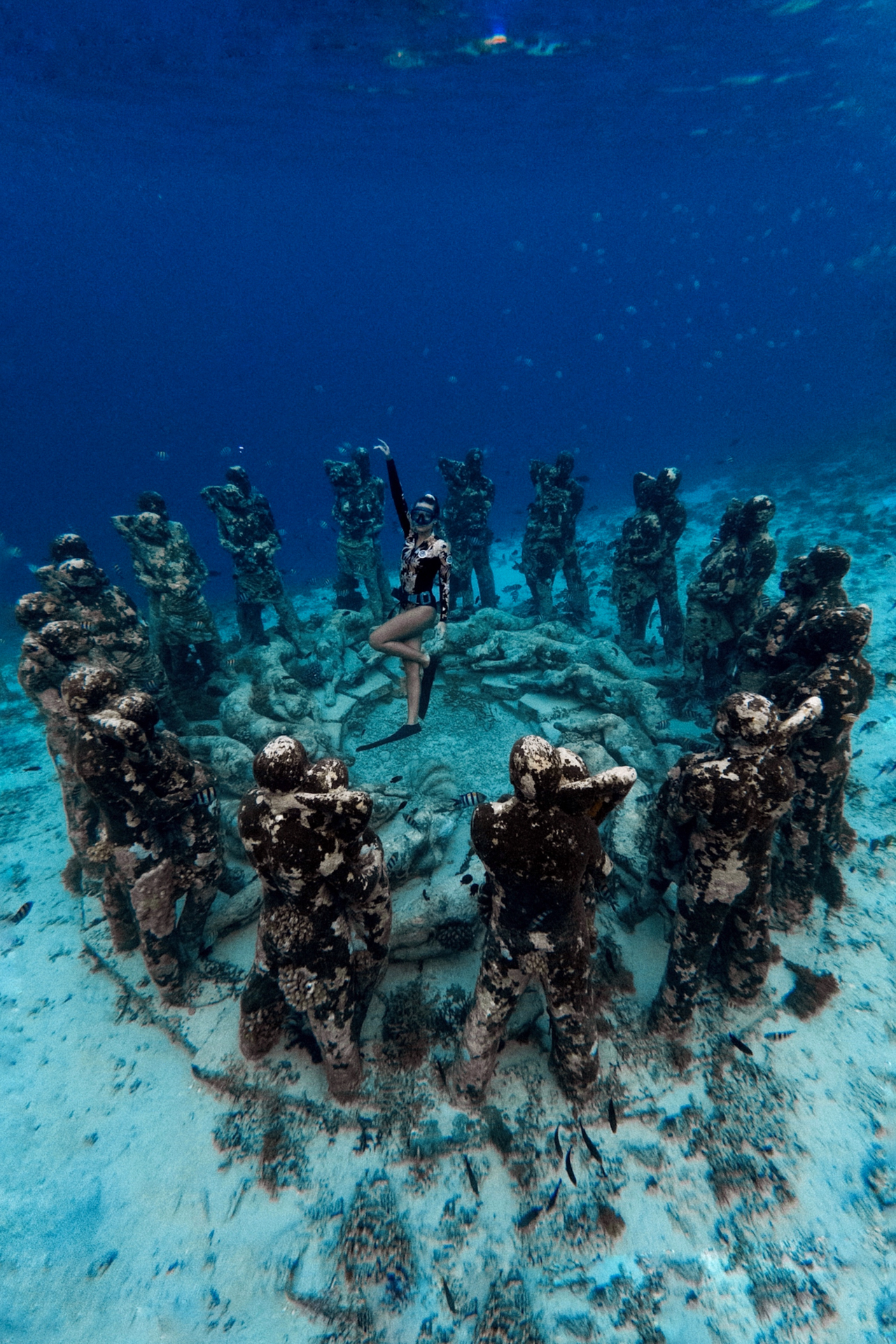 Freediver exploring underwater Nest statues at Gili Meno, Indonesia