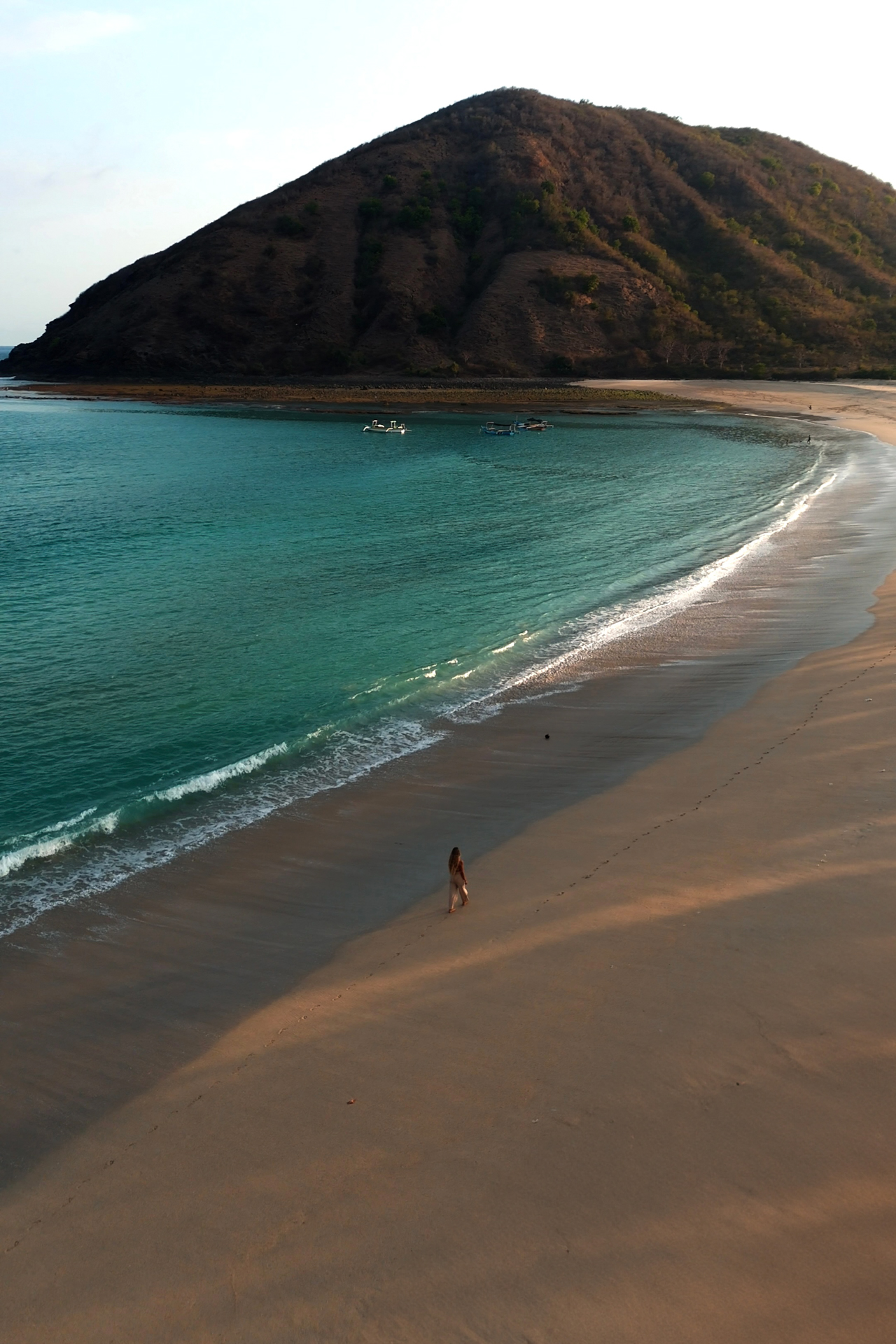 Mawun Beach Lombok with calm turquoise water and sweeping sandy shoreline