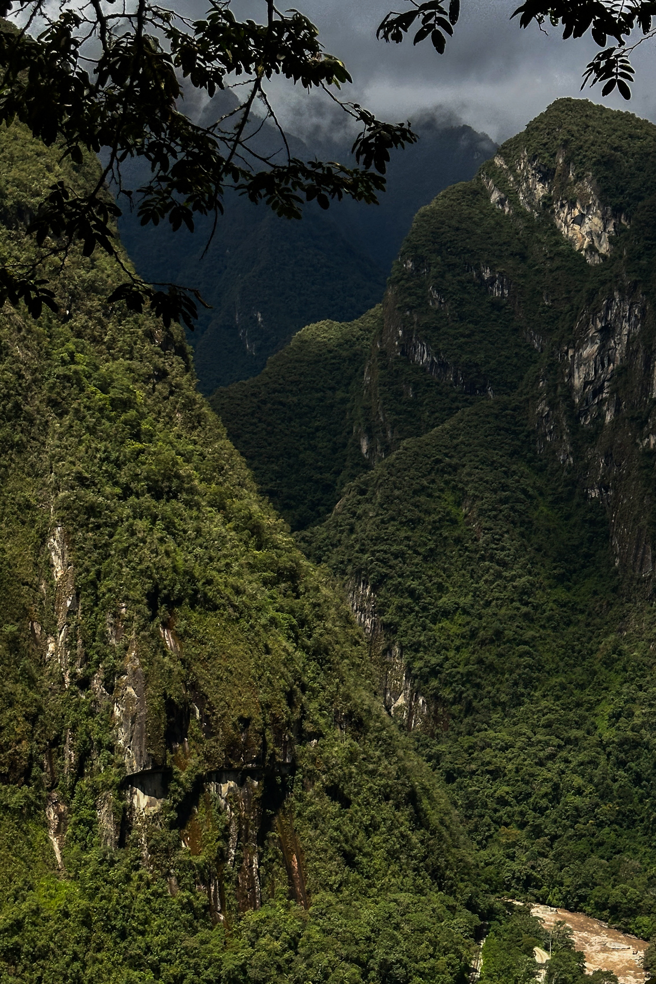 Lush green mountains and deep valley surrounding Machu Picchu, Peru