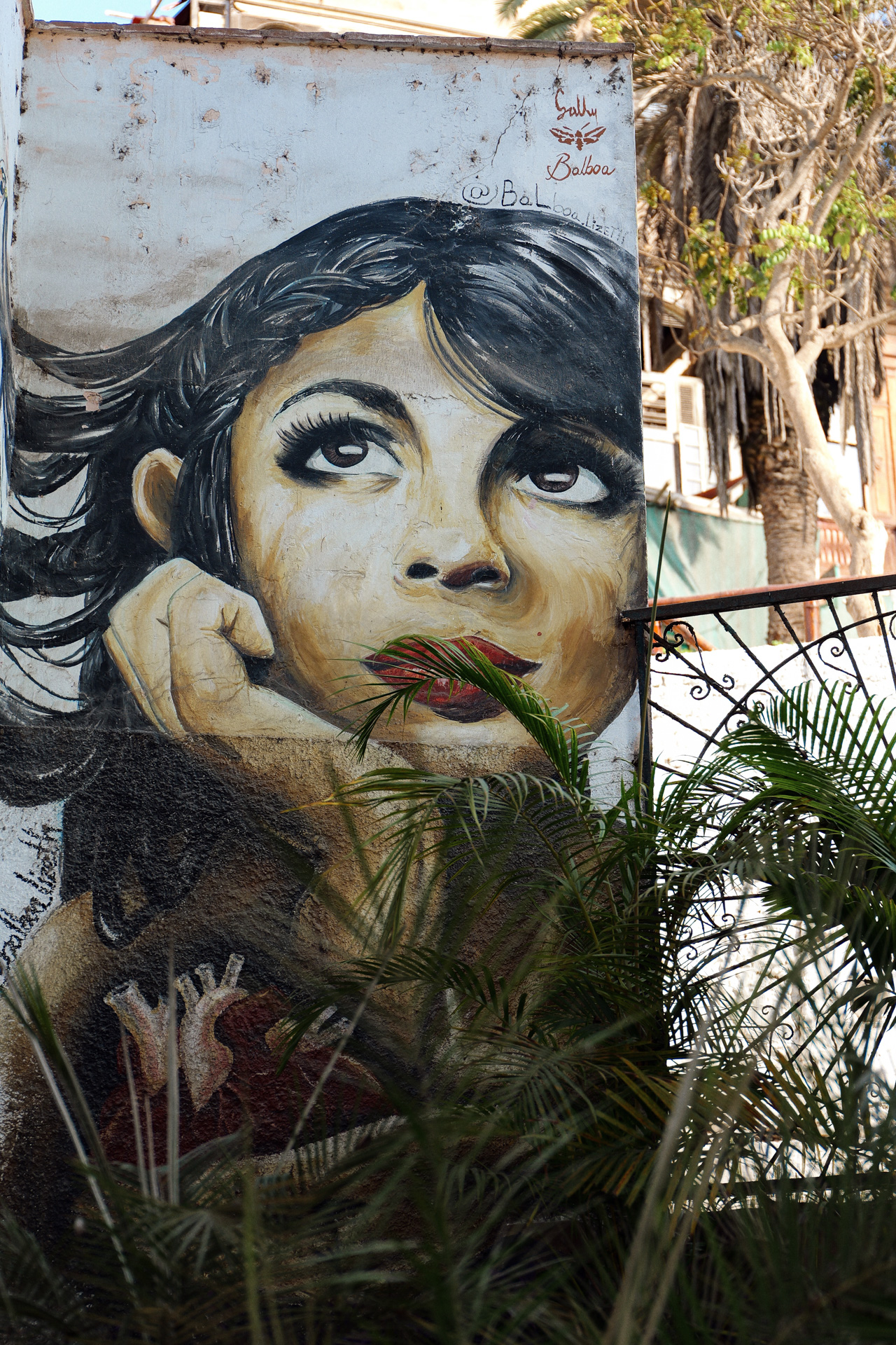 Street art mural of a woman surrounded by tropical plants in Barranco, Lima
