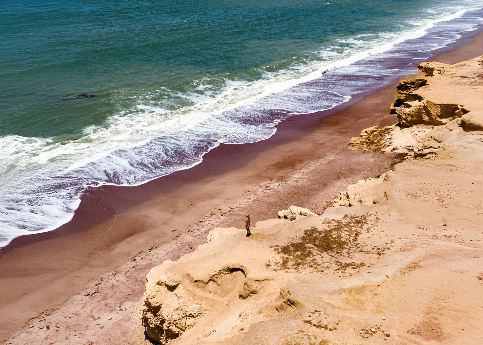 Dramatic coastal cliffs and turquoise ocean in Paracas National Reserve, Peru
