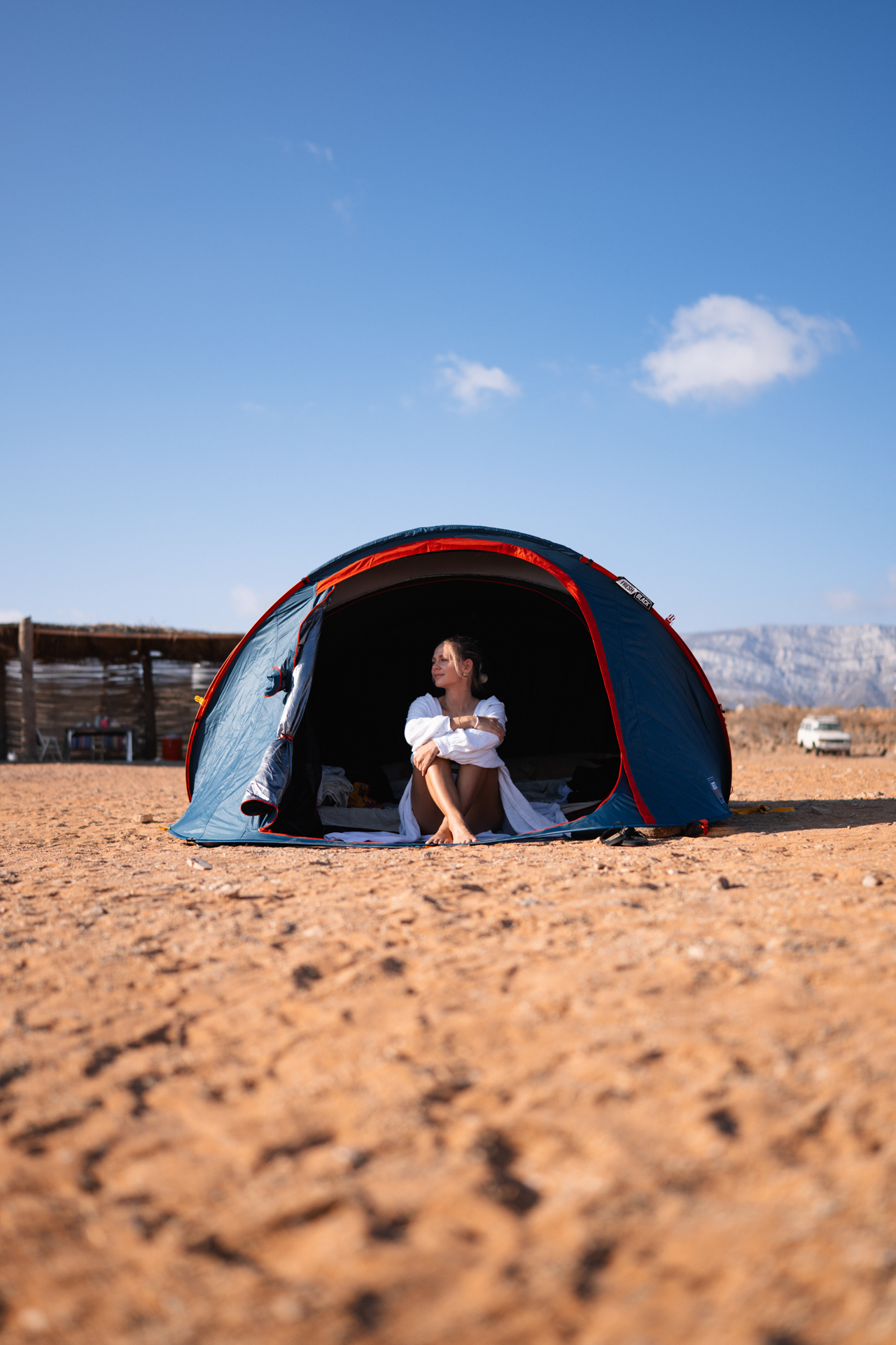 Woman sitting in a tent at basecamp Detwah Lagoon in Socotra, Yemen