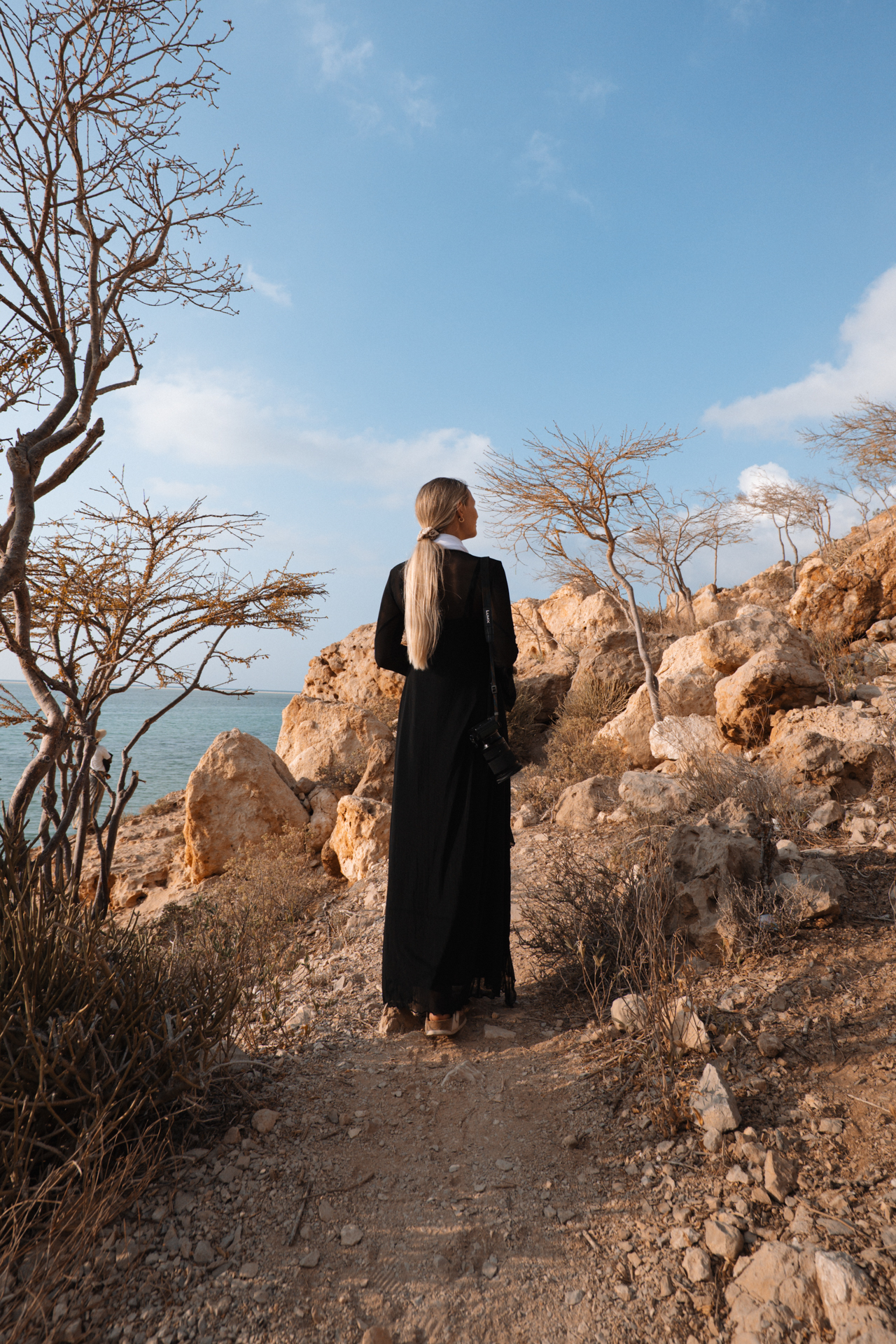 Woman standing at a beautiful landscape at Detwah Lagoon in Socotra