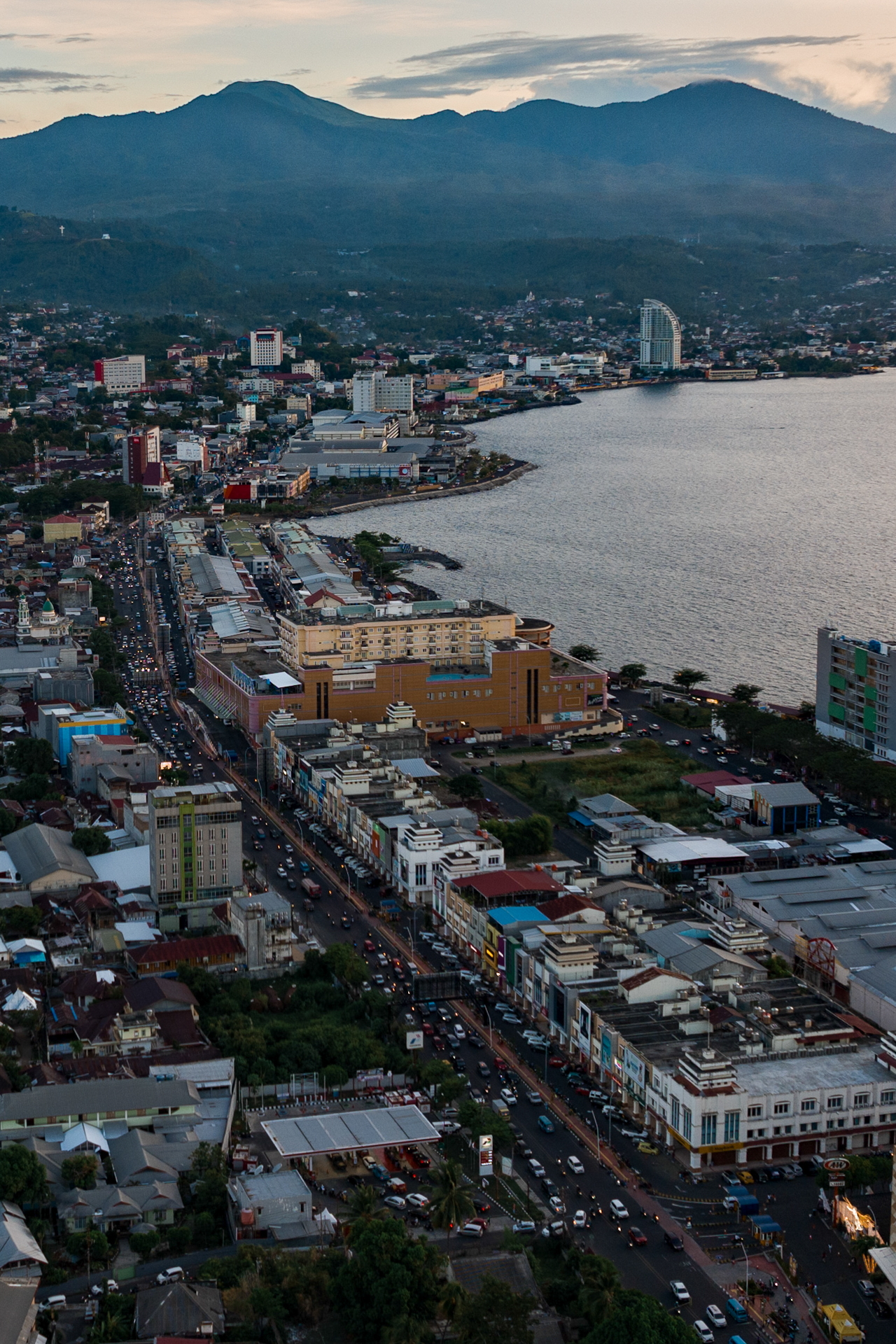 Manado city coastline with mountains at sunset, North Sulawesi