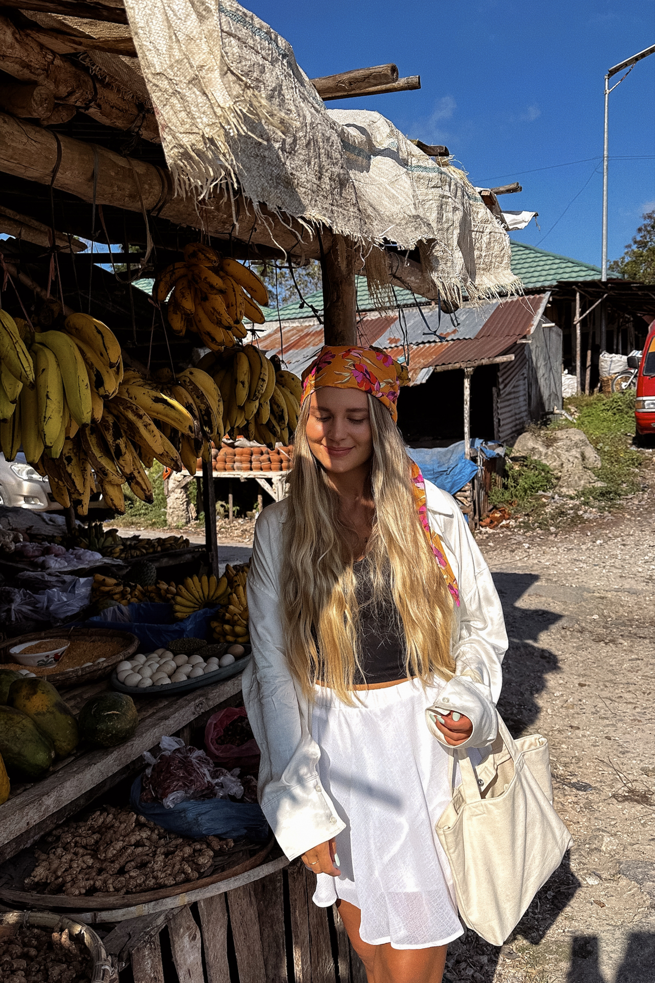 Woman at Waikabubak local market with fresh tropical fruits, Sumba Island