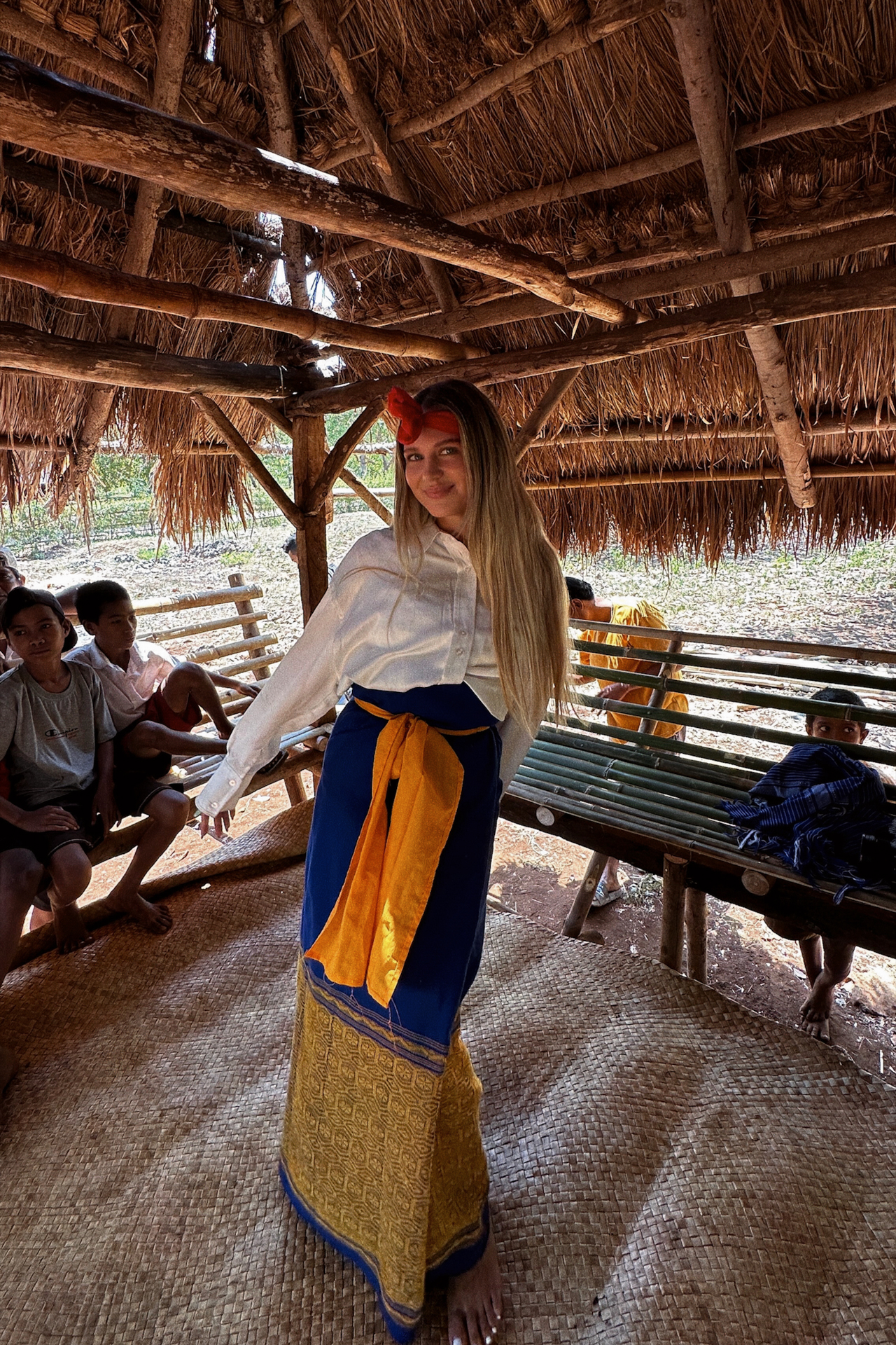 Woman wearing traditional Sumba fabric in village hut
