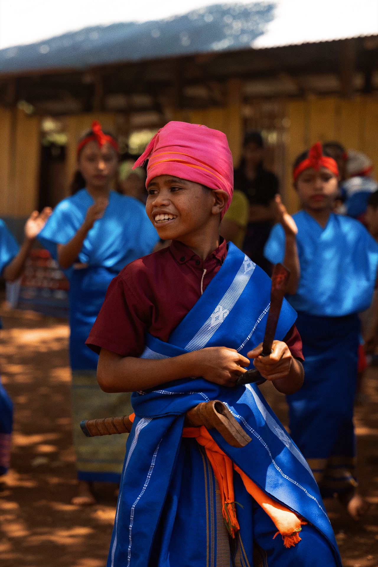 Local boy in traditional attire during village ceremony, Sumba Island