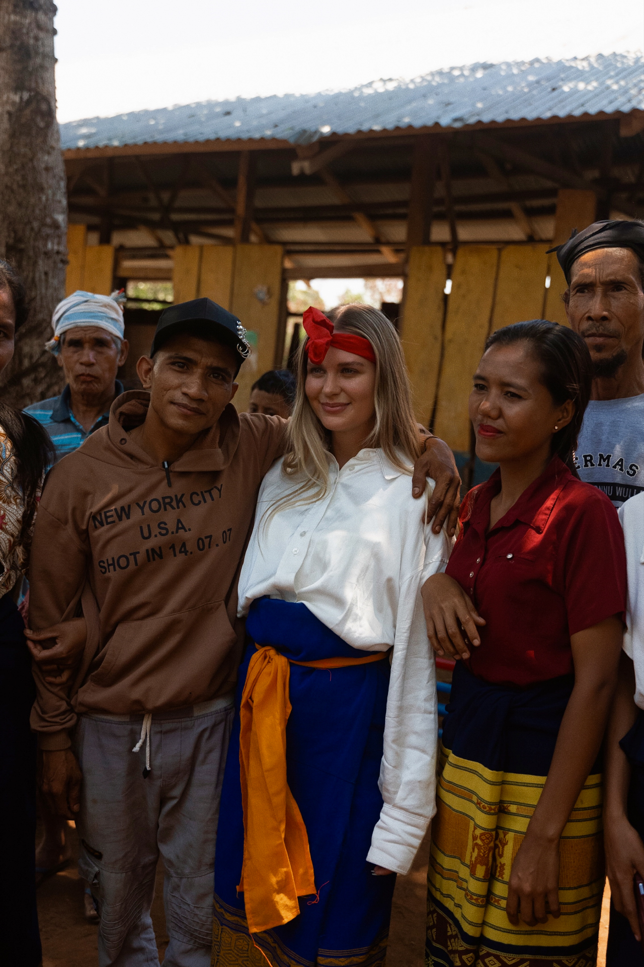 Woman with locals in traditional village, Sumba Island Indonesia