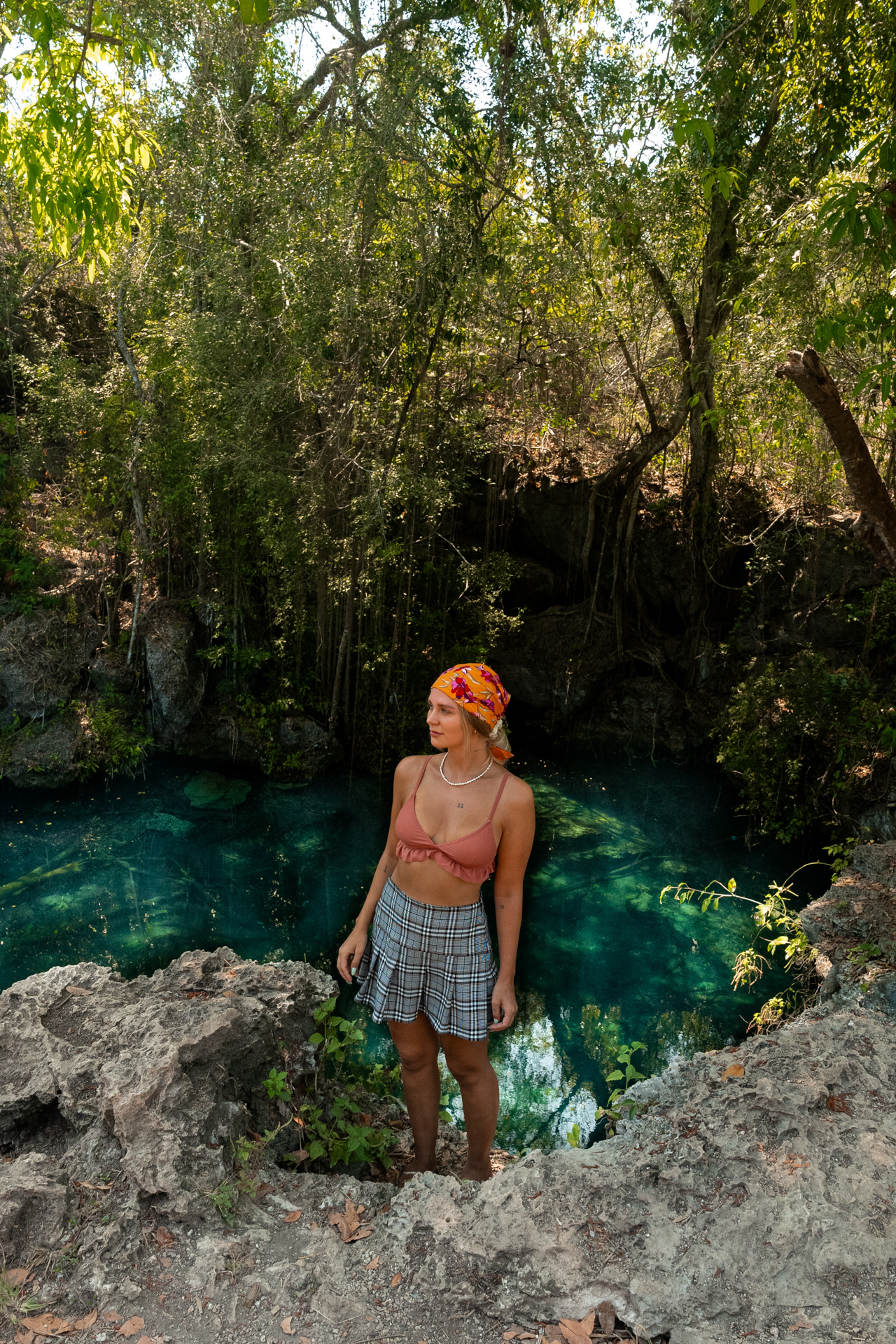 Woman at Weepaneba Lagoon surrounded by tropical forest, Kodi Sumba