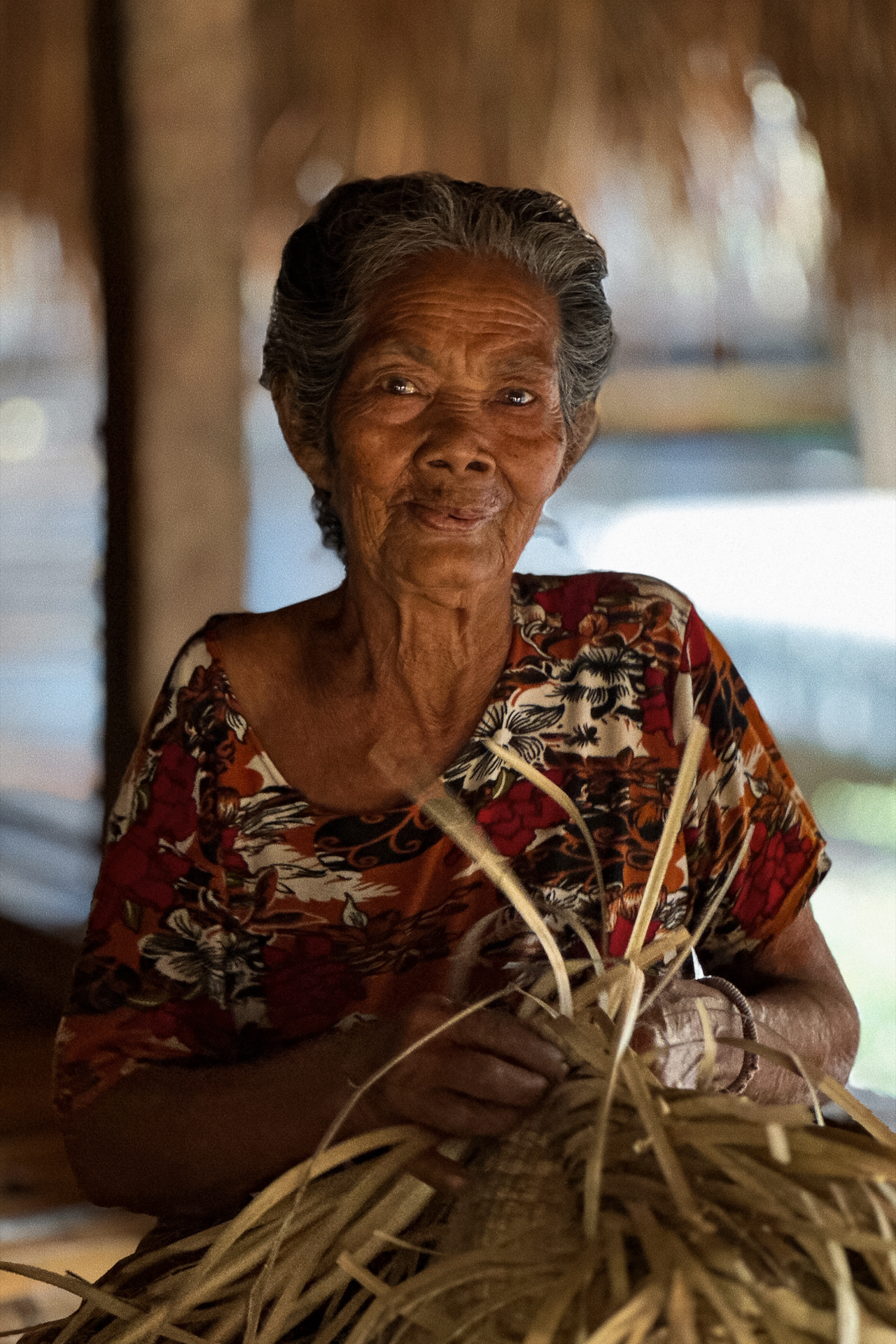Local woman weaving traditional basket in Sumba village