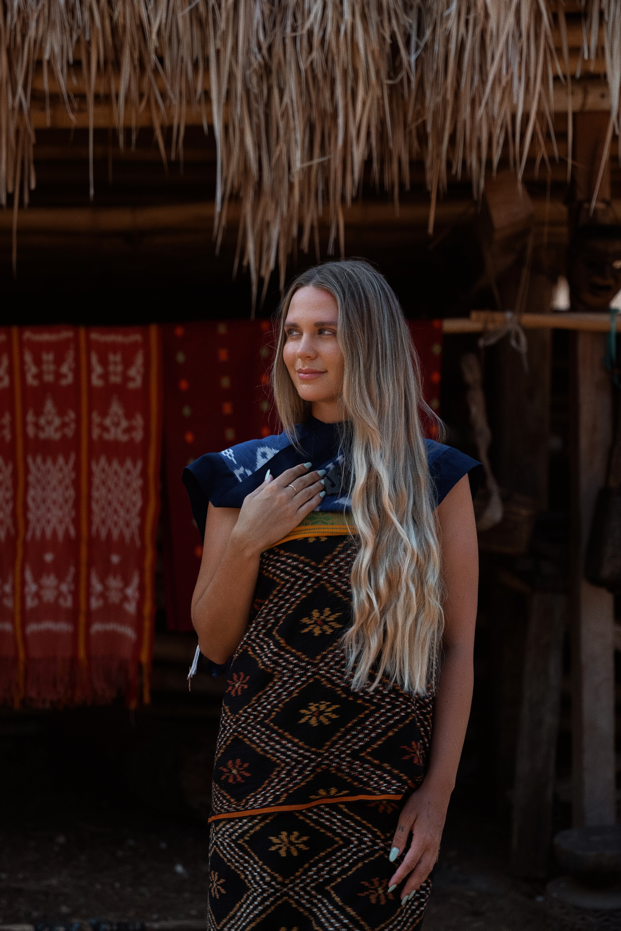 Woman wearing traditional Sumba fabric in village setting