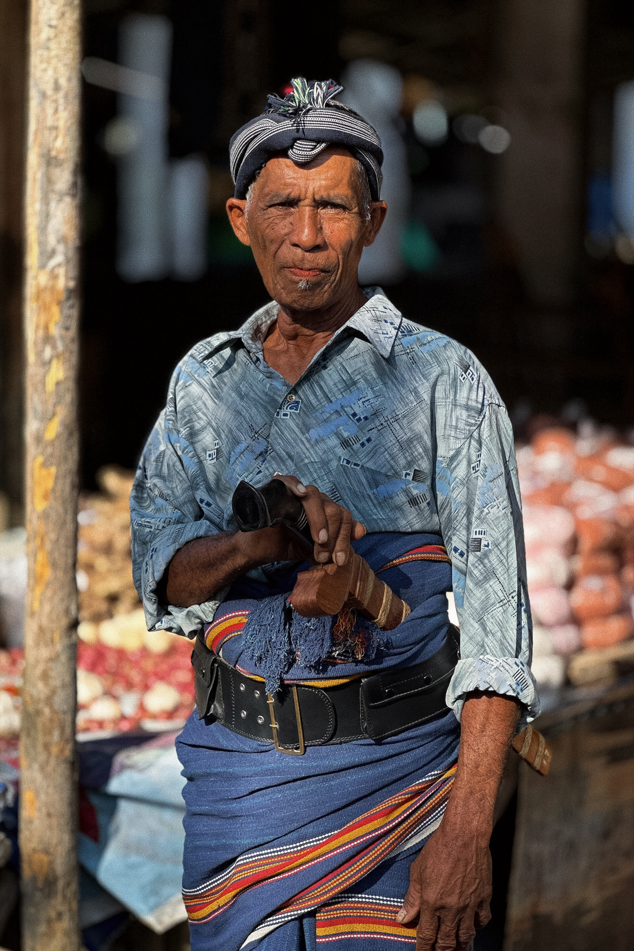 Local man in traditional attire at Sumba market