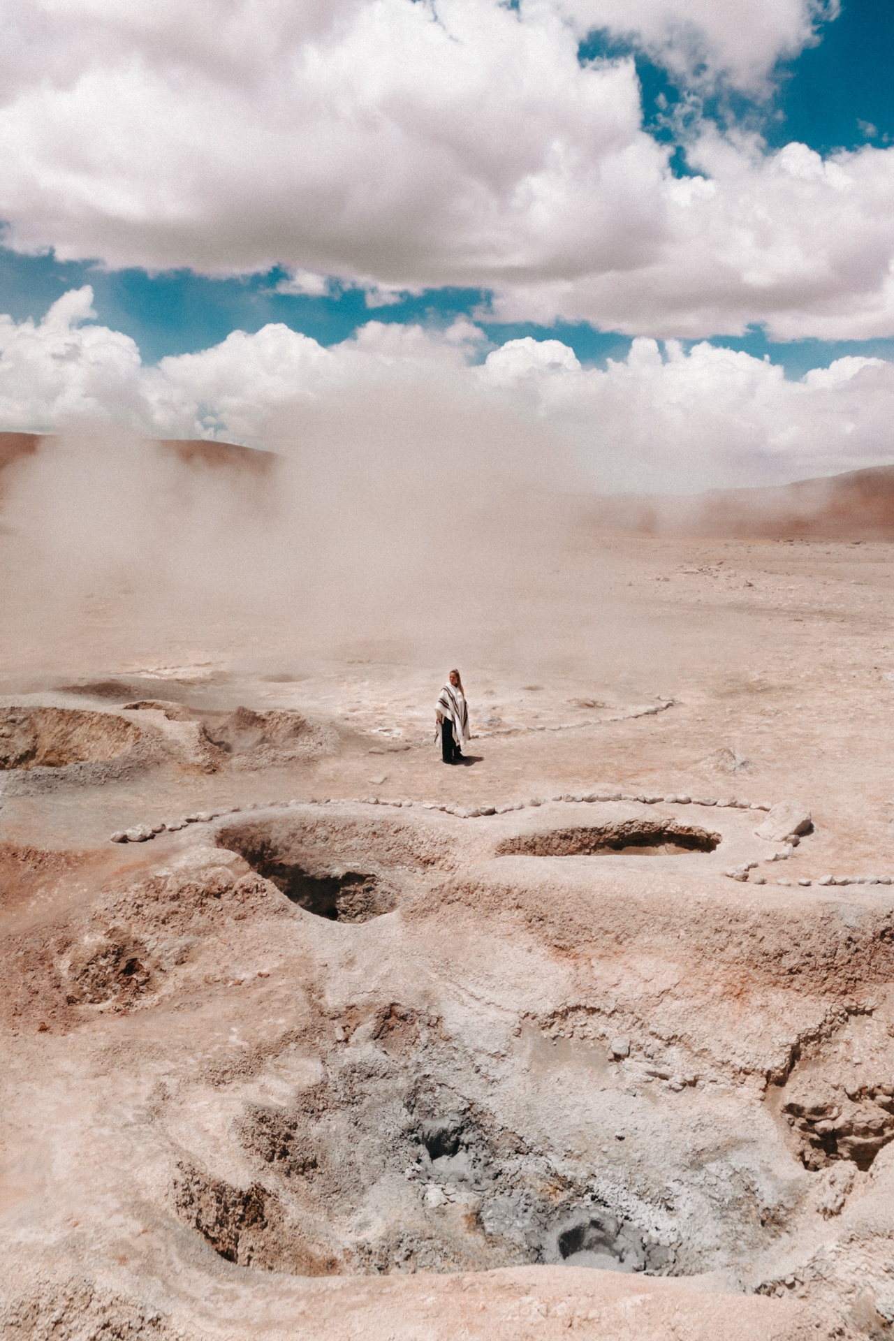 Among steaming vents and bubbling mud pools at Sol de Mañana, where the earth breathes beneath your feet.