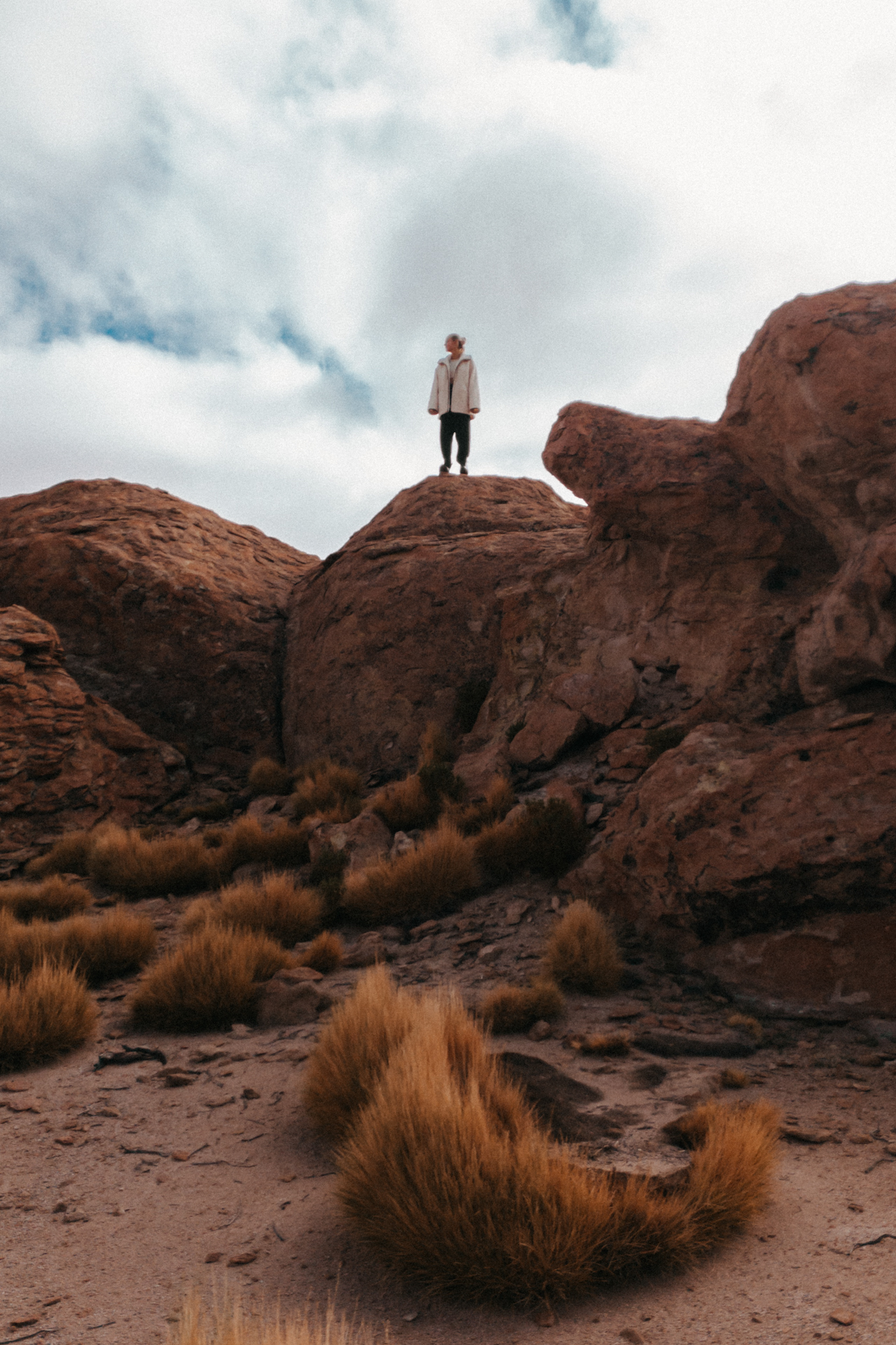 Standing among wind-sculpted rocks in the vast, otherworldly Siloli Desert.
