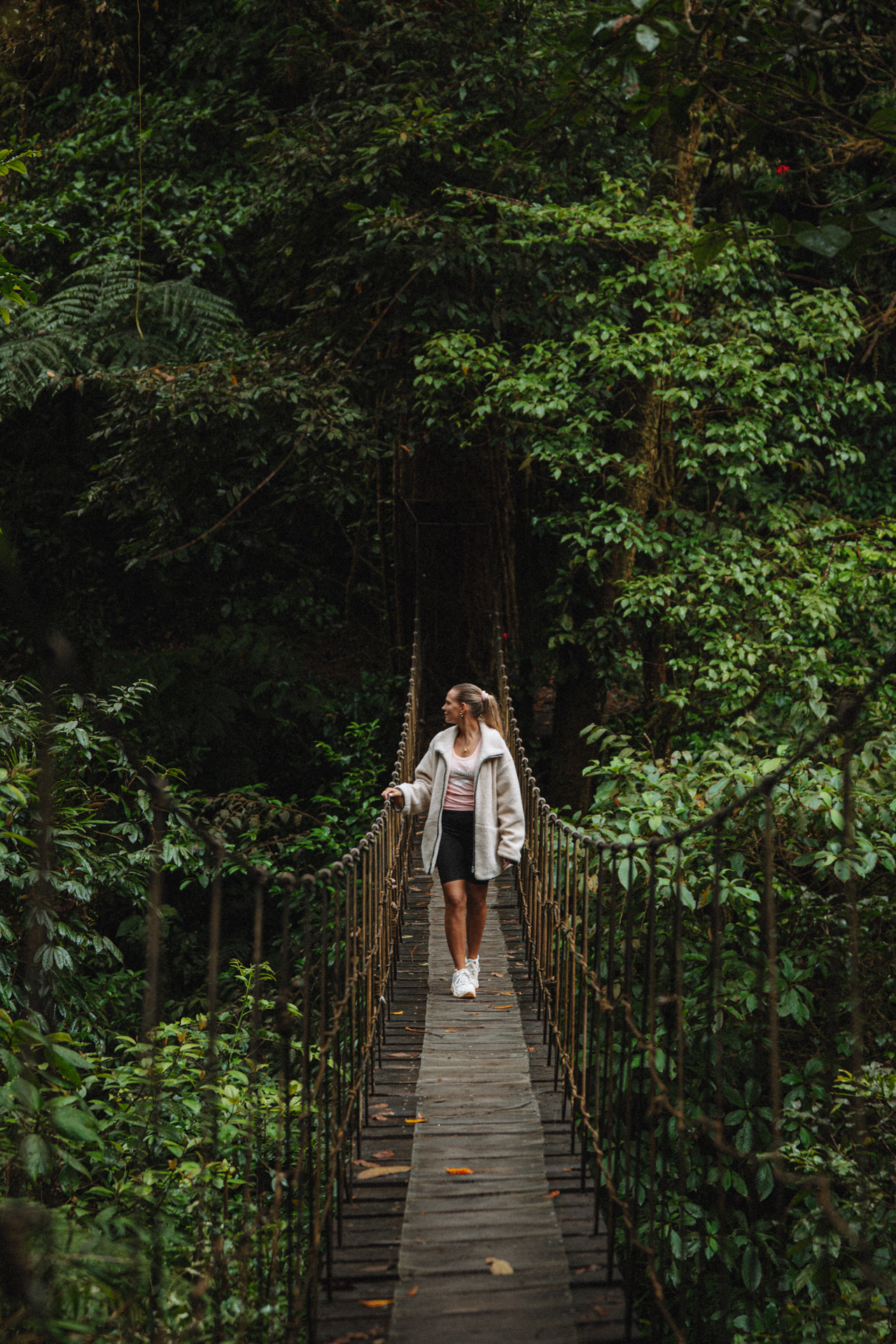 El Tigre Waterfalls in Monteverde Costa Rica with a woman on a hanging bridge