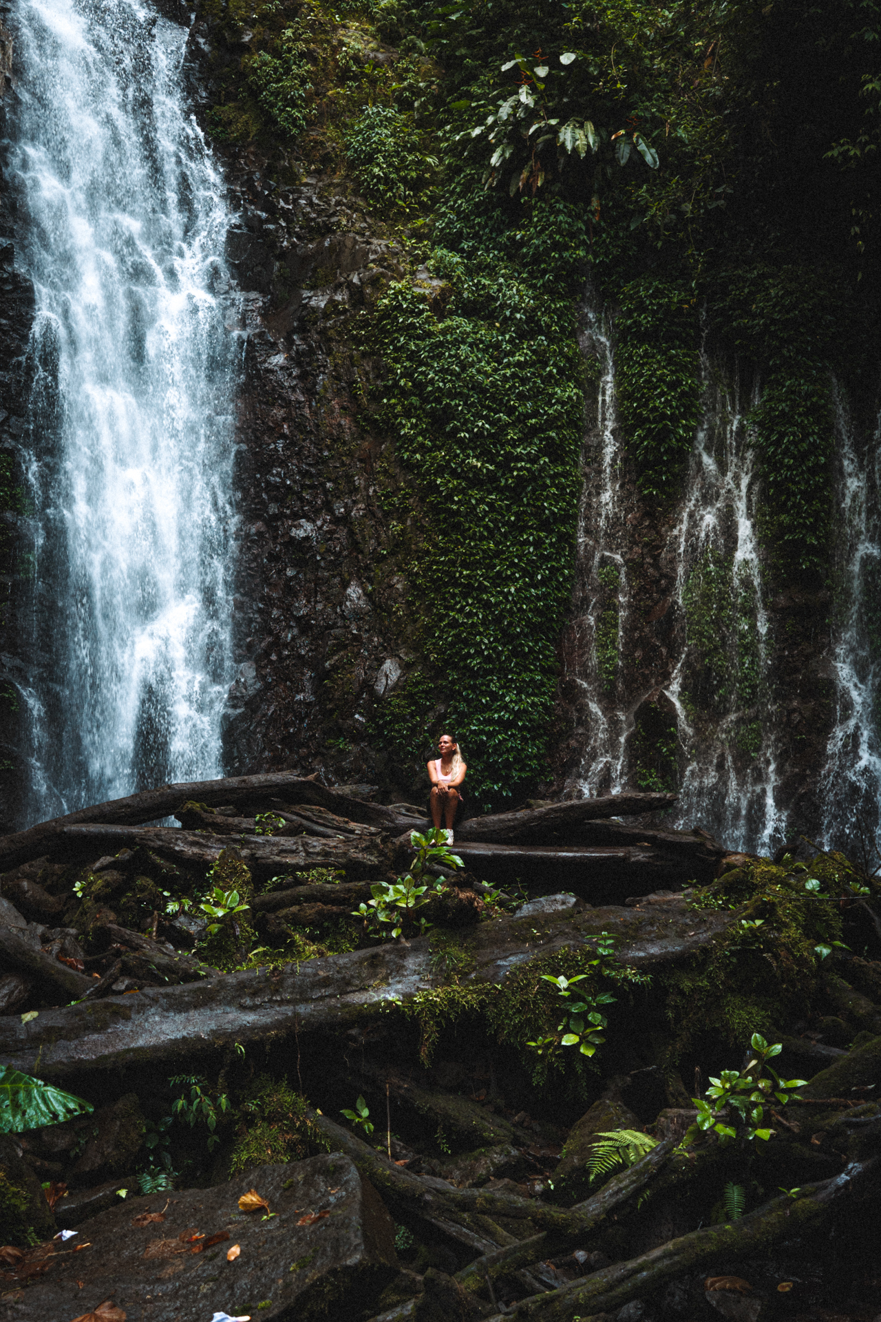 Woman sitting in front of a El Tigre Waterfall in Monteverde Costa Rica
