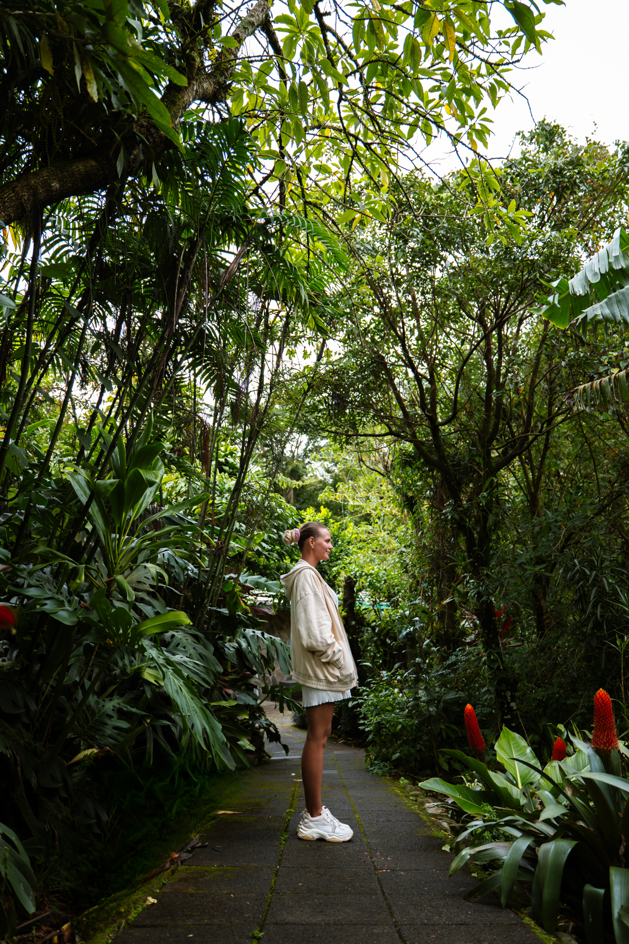 Woman standing on a lush garden path in Santa Elena Monteverde Costa Rica