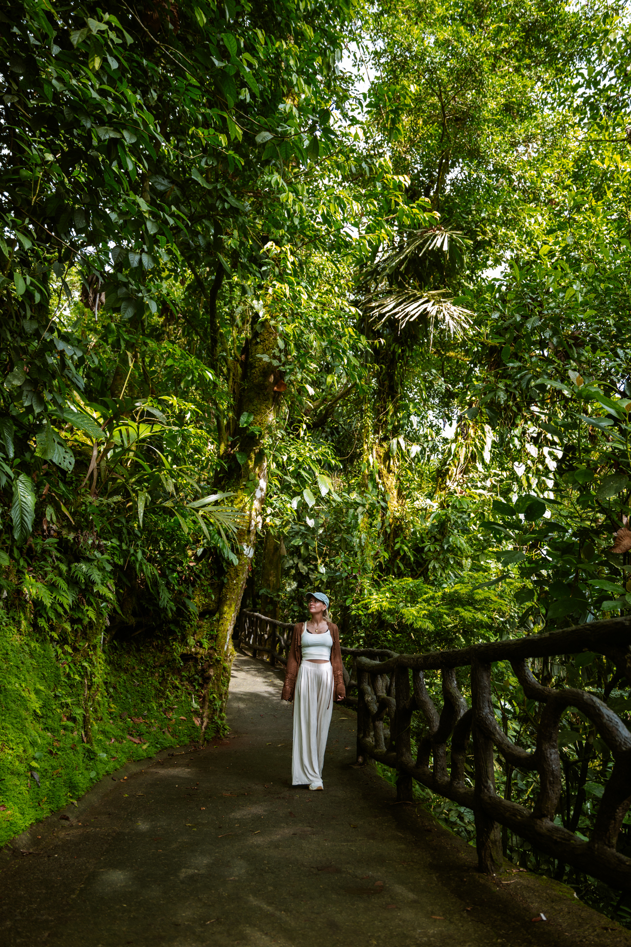 Woman walking through lush rainforest in La Fortuna Costa Rica on a jungle trail