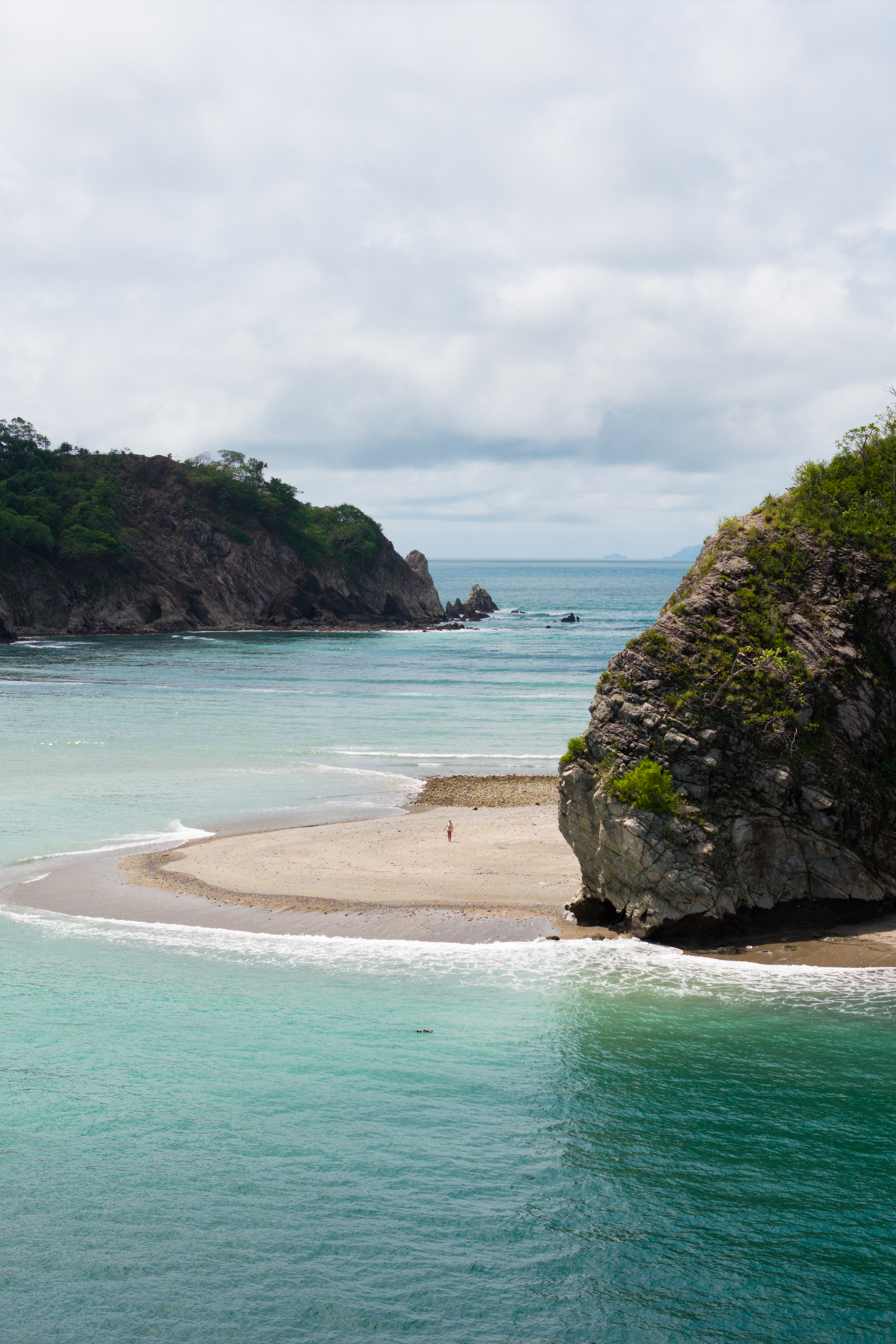 Tortuga Island Costa Rica beach with sandbar, turquoise water, and rocky coastline