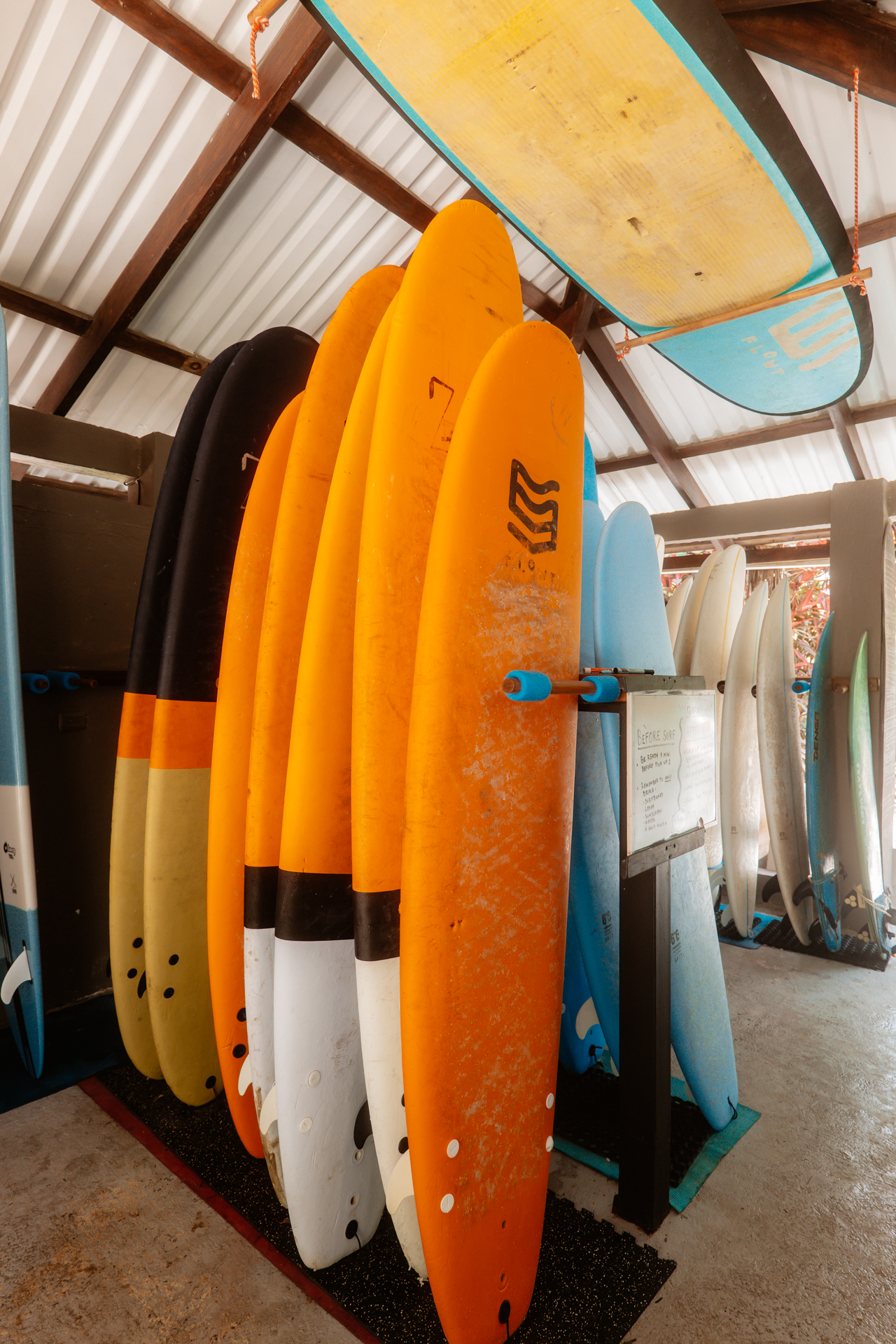 Colorful surfboards stacked in a surf shop in Santa Teresa, Costa Rica