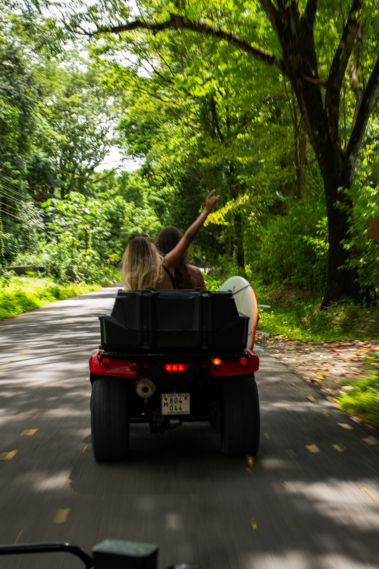 2 girls driving an ATV in Santa Teresa, Costa Rica