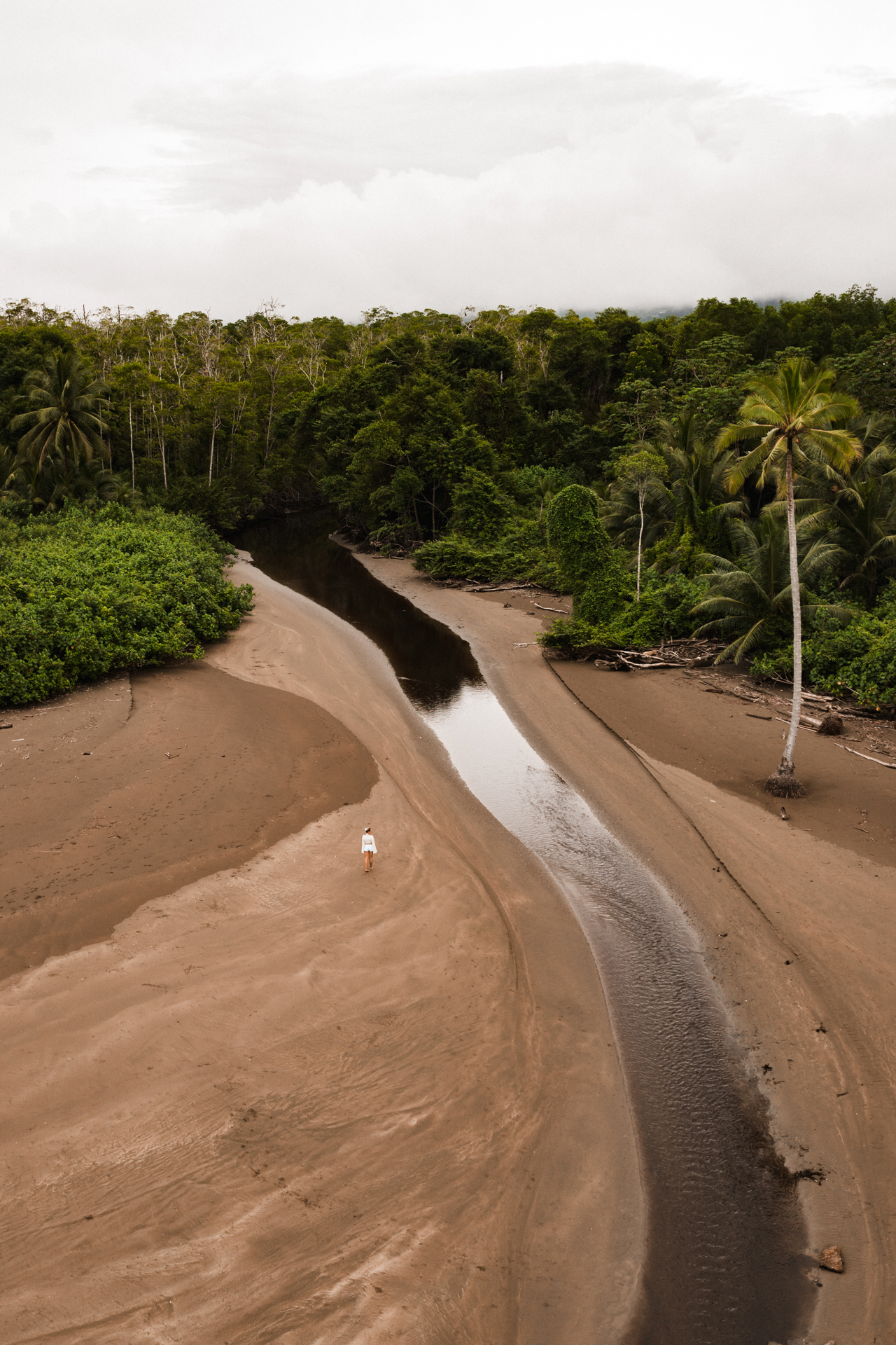 Aerial view of river flowing into the ocean in Uvita Costa Rica surrounded by tropical rainforest
