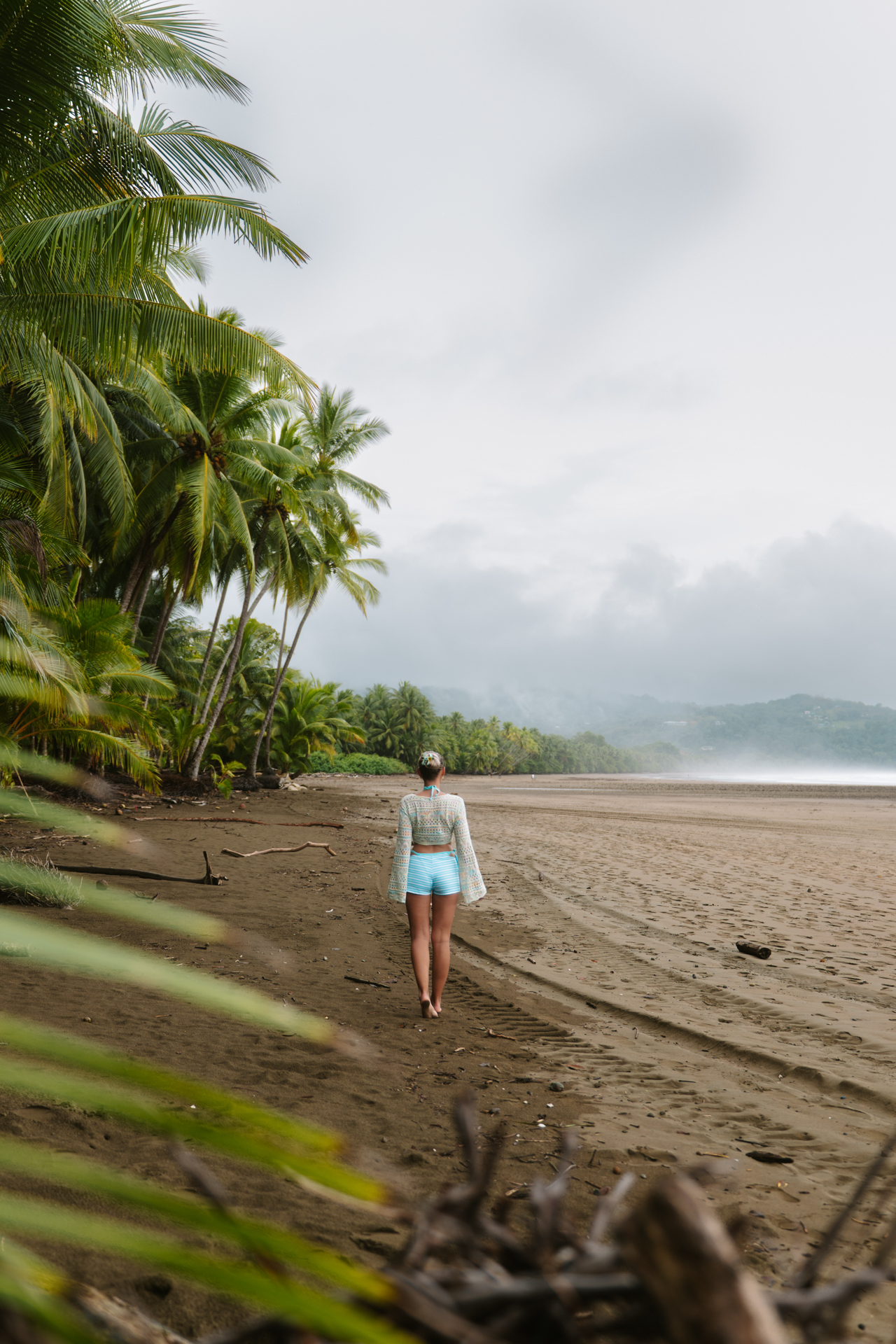 Woman walking on playa Uvita in Costa Rica