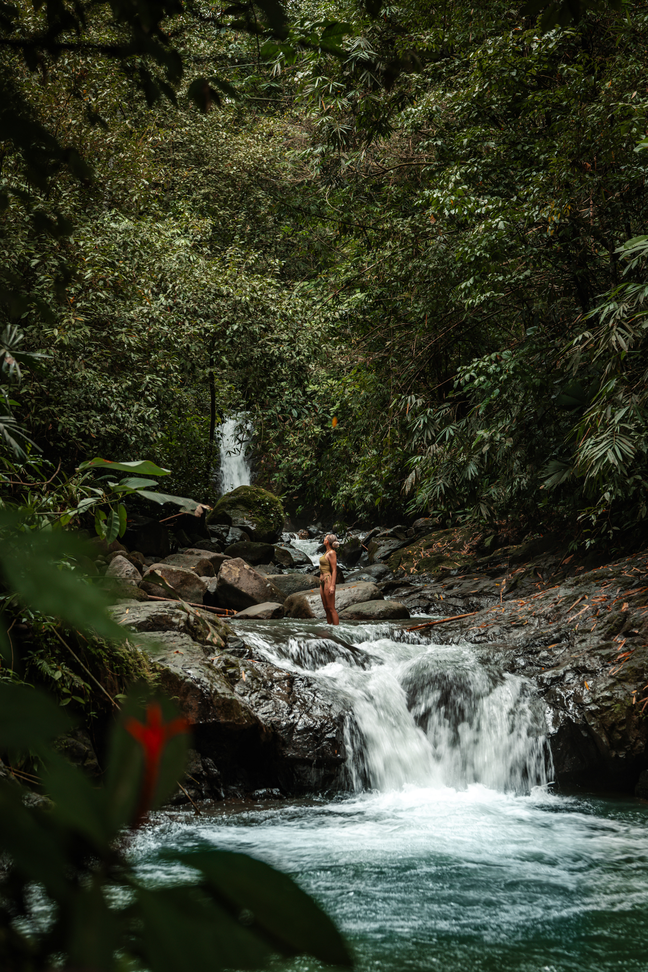 Woman standing at the Uvita Waterfall in Costa Rica