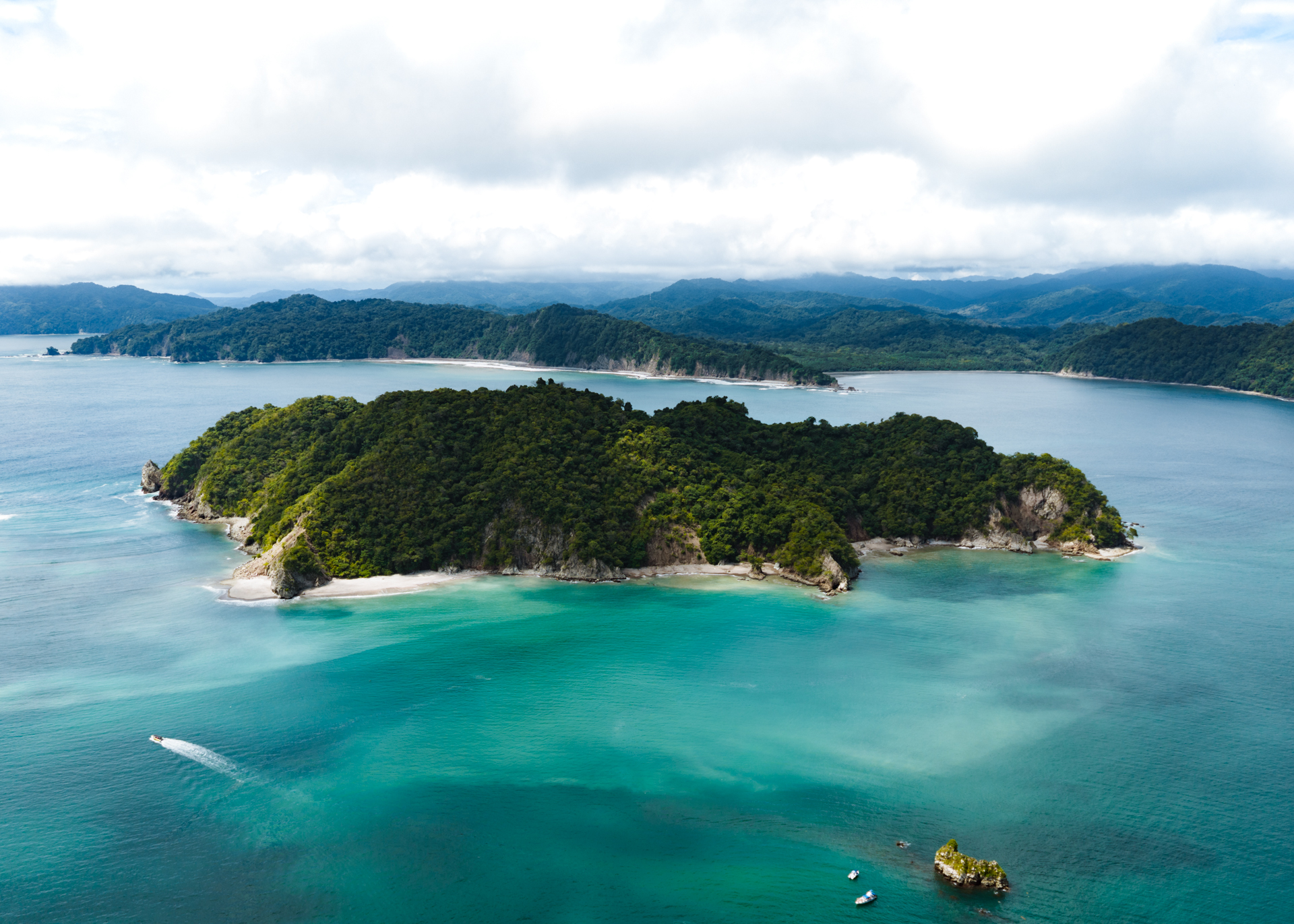 Tortuga Island Costa Rica aerial view with turquoise water, tropical forest, and white sandy beaches