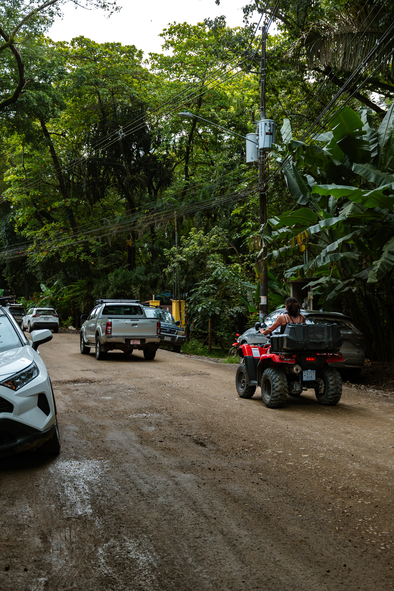 Getting around Santa Teresa Costa Rica by ATV on a tropical dirt road surrounded by jungle