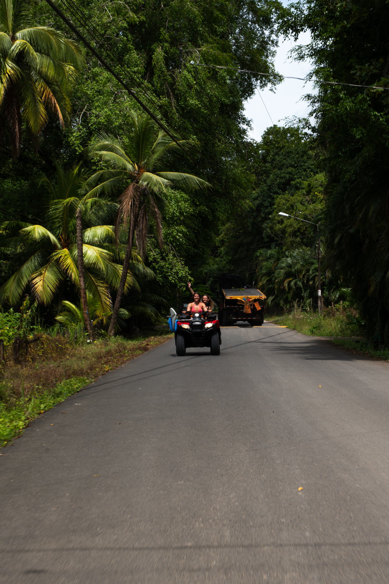 2 girls driving an ATV in Santa Teresa, Costa Rica