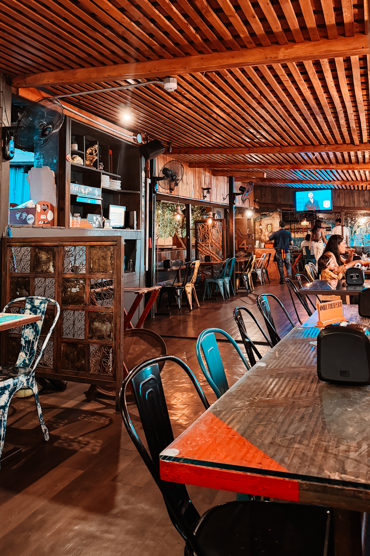 Interior of Simmer Down restaurant in Santa Ana with wooden ceiling and dining area