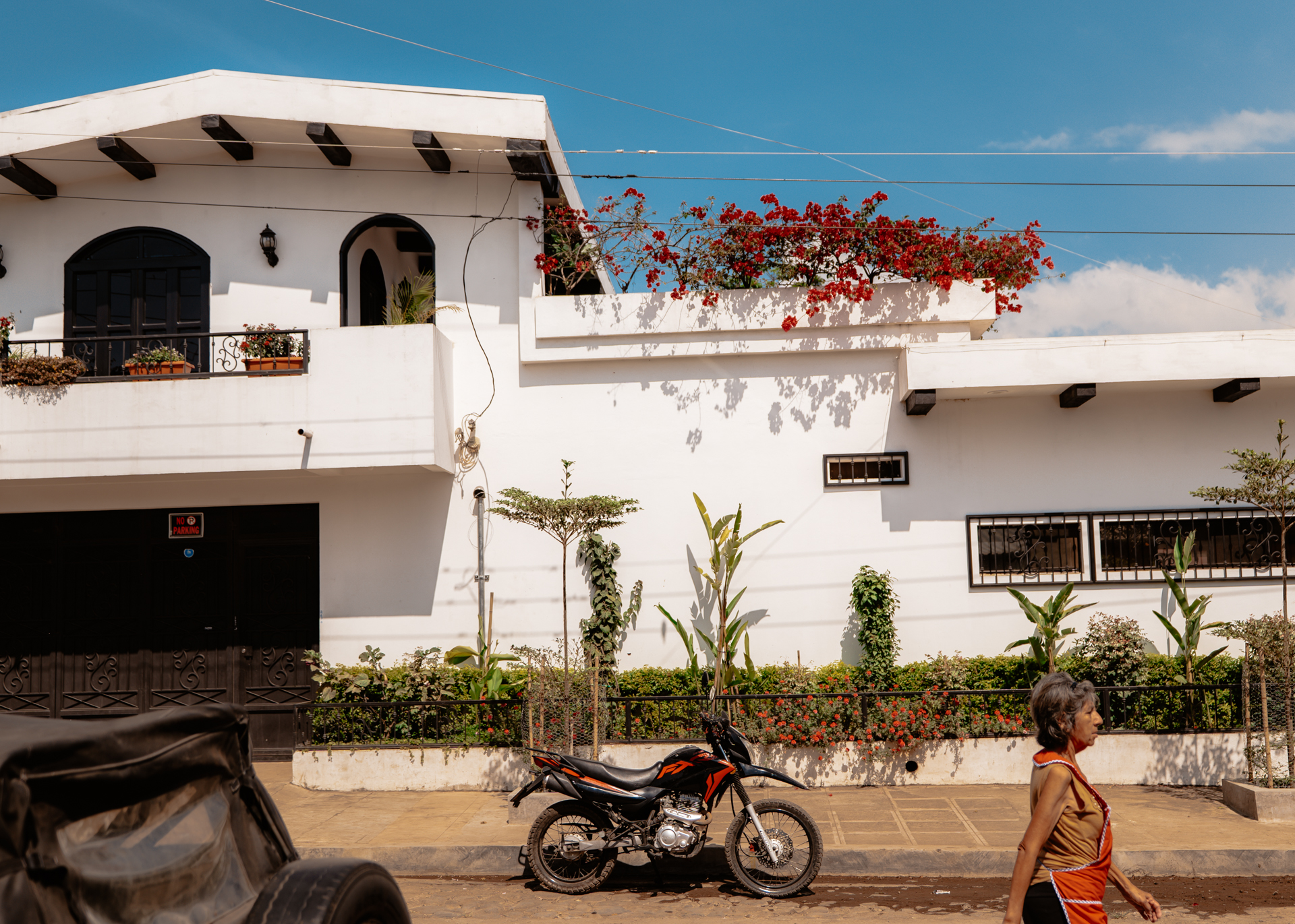 White colonial house with red bougainvillea flowers in Nahuizalco along the Ruta de las Flores in El Salvador