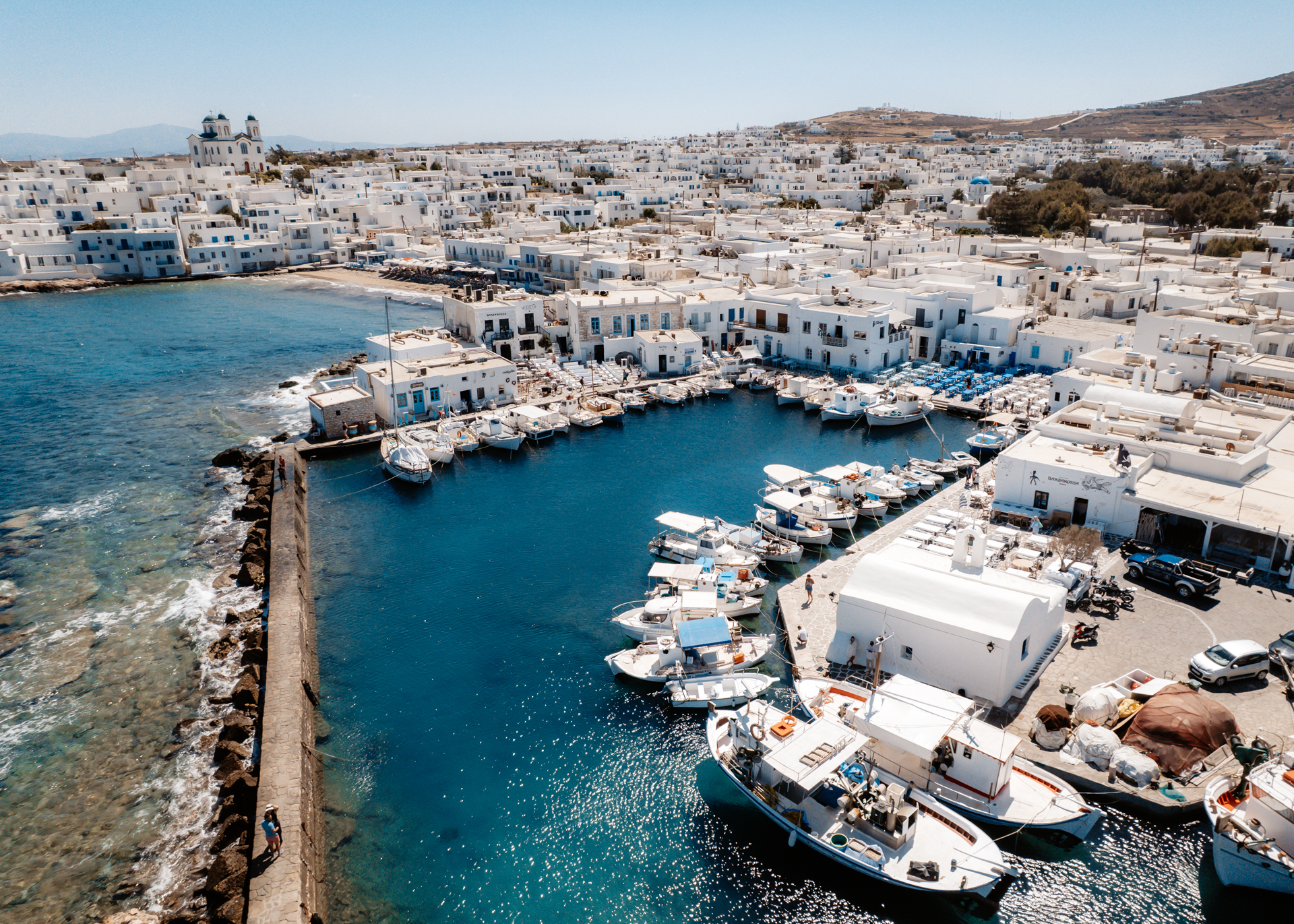 Paros harbor with fishing boats and white houses in Naoussa village, Greece