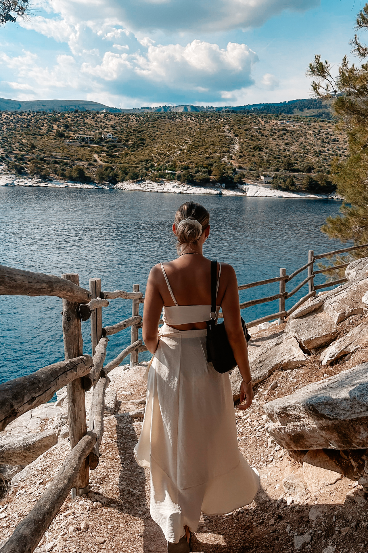 Woman walking along coastal path with sea view in Thassos island Greece